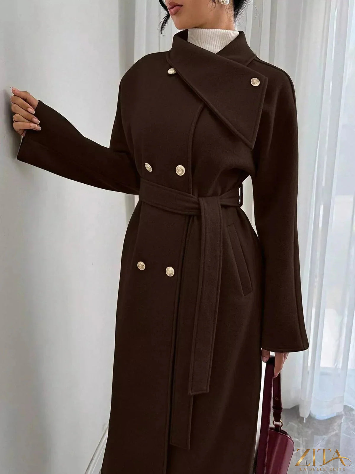 Zita La Belle Elite double-breasted longline coat hanging on a rack, showcasing classic design and tailored fit.