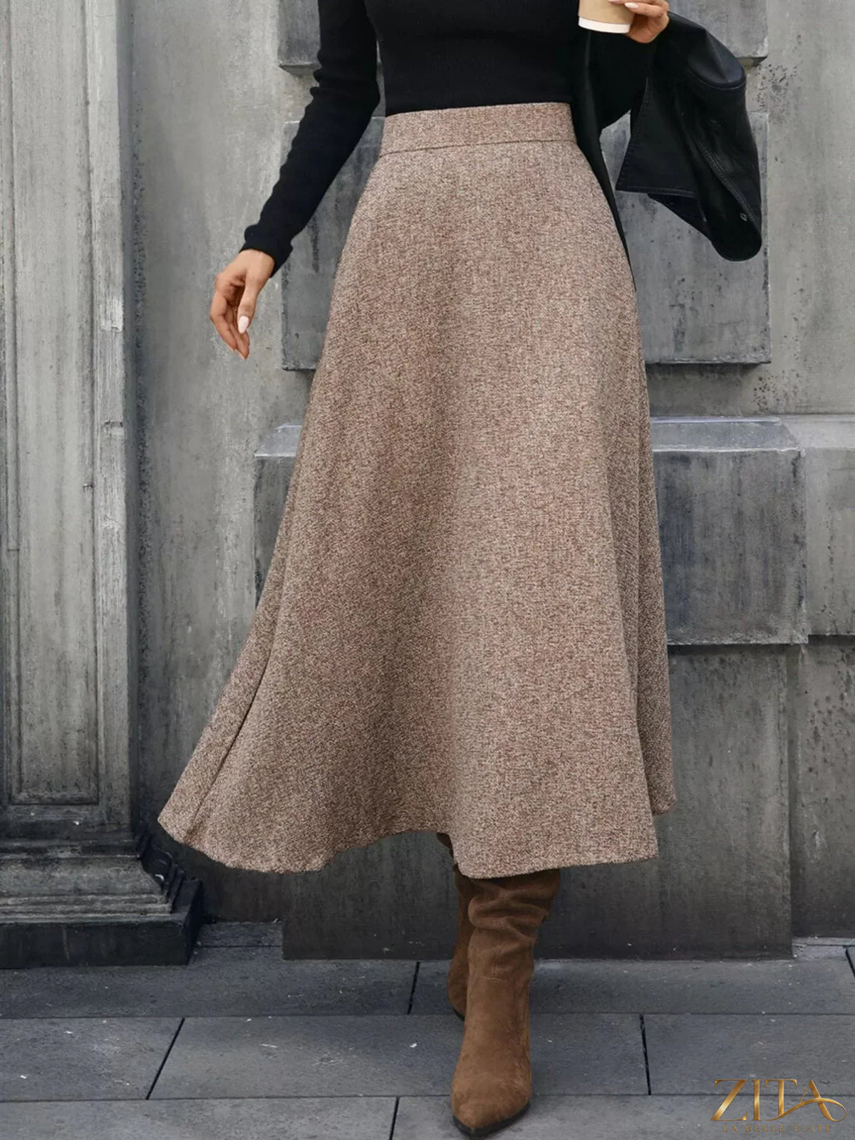 A-line midi skirt from Trendsi featuring a flowy design, high waist, and soft fabric, shown in a natural pose.