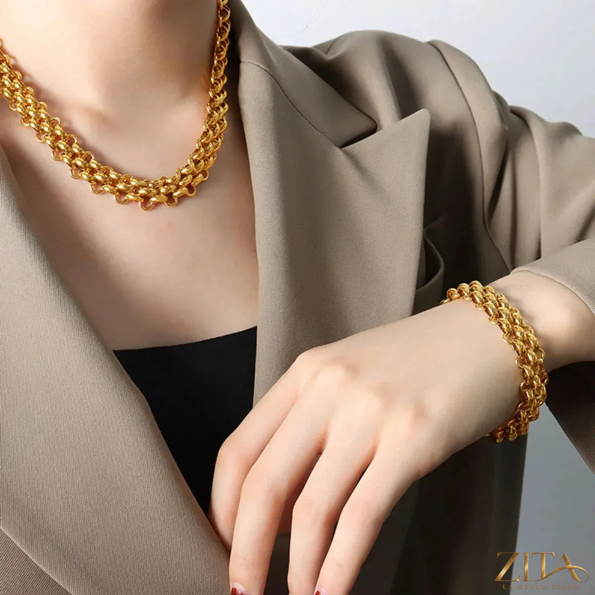 Gold chain link jewelry set featuring a necklace and bracelet with sleek, interconnected links in a stylish design.