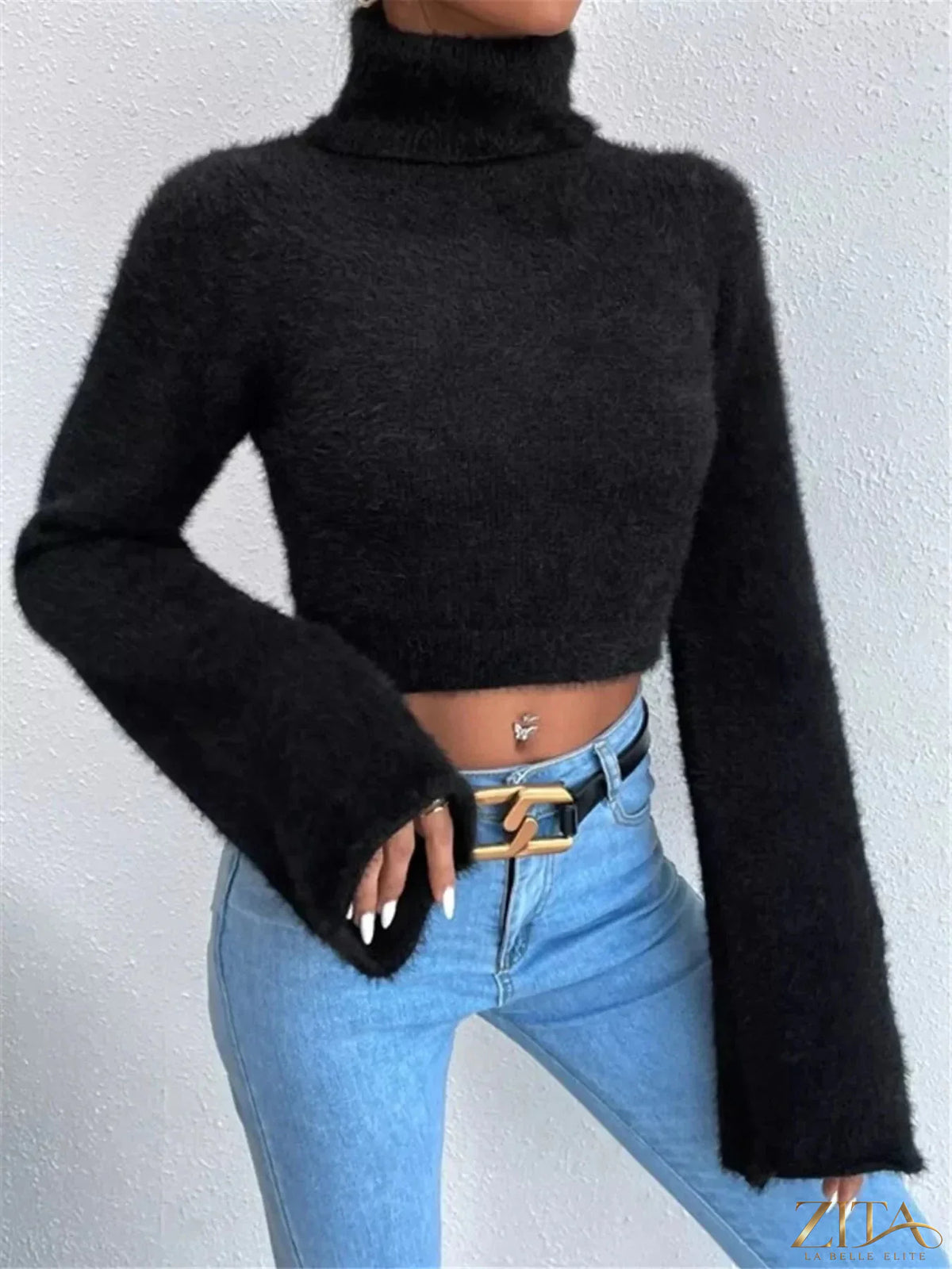 Cream-colored turtleneck sweater with flare sleeves from Trendsi, showcasing a cozy knit design and stylish oversized fit.