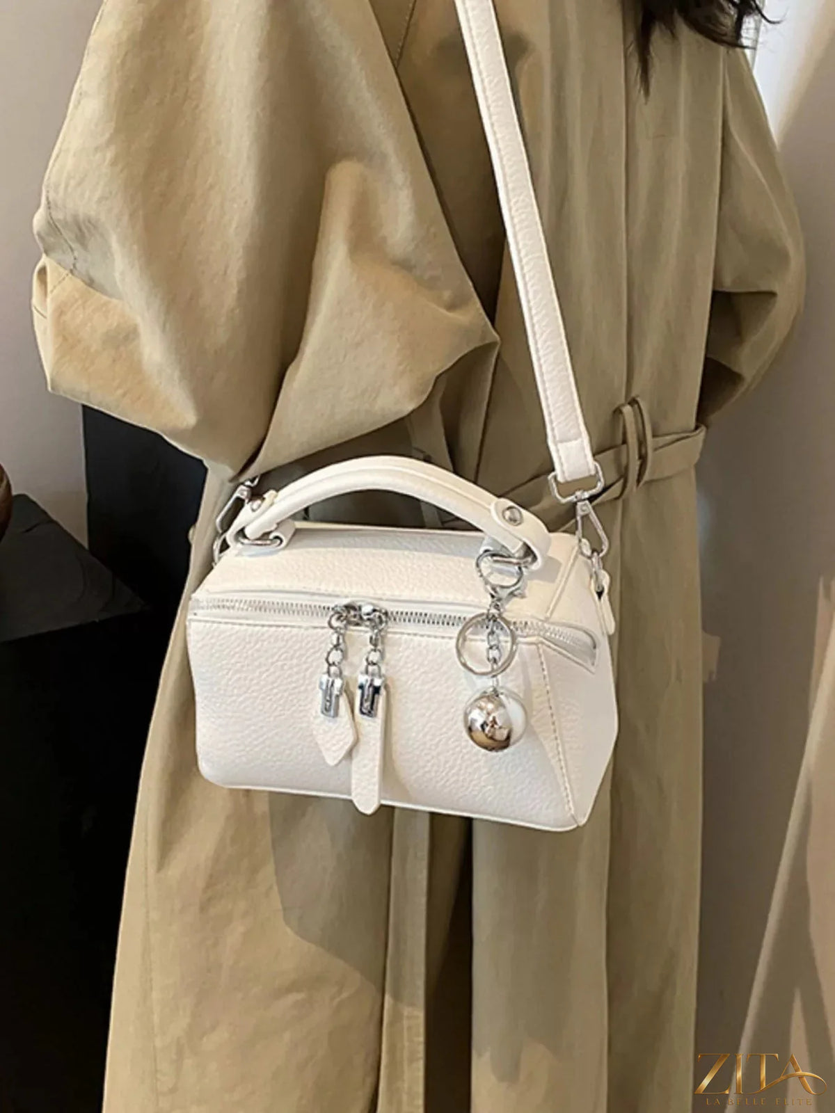 Textured leather handbag by Trendsi with gold-tone hardware and top handle, showcasing its stylish, durable design.
