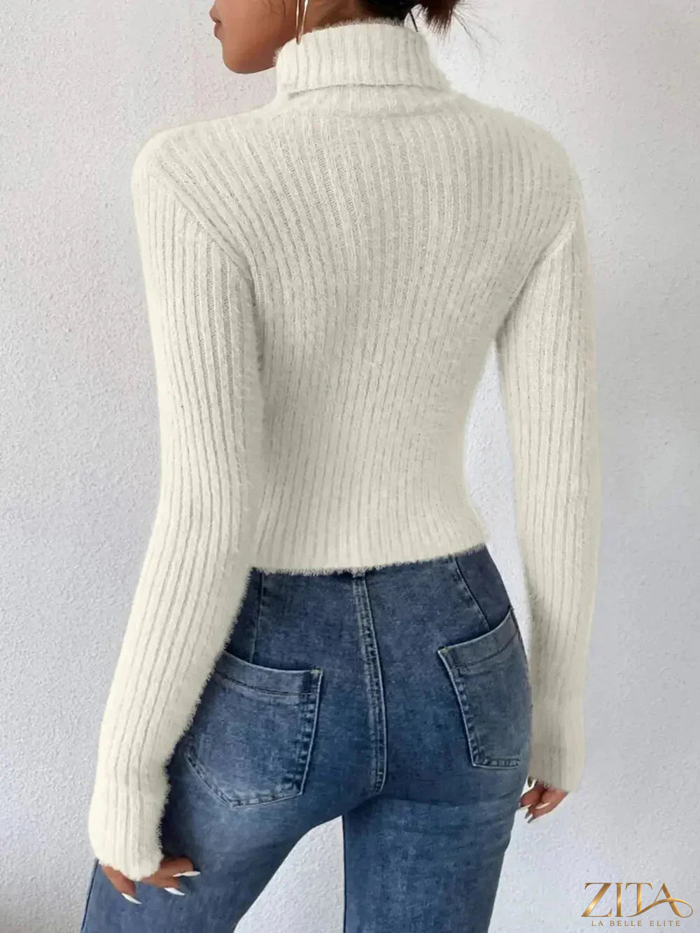 Ribbed turtleneck long sleeve sweater from Trendsi, featuring a snug fit and textured ribbing in neutral color.