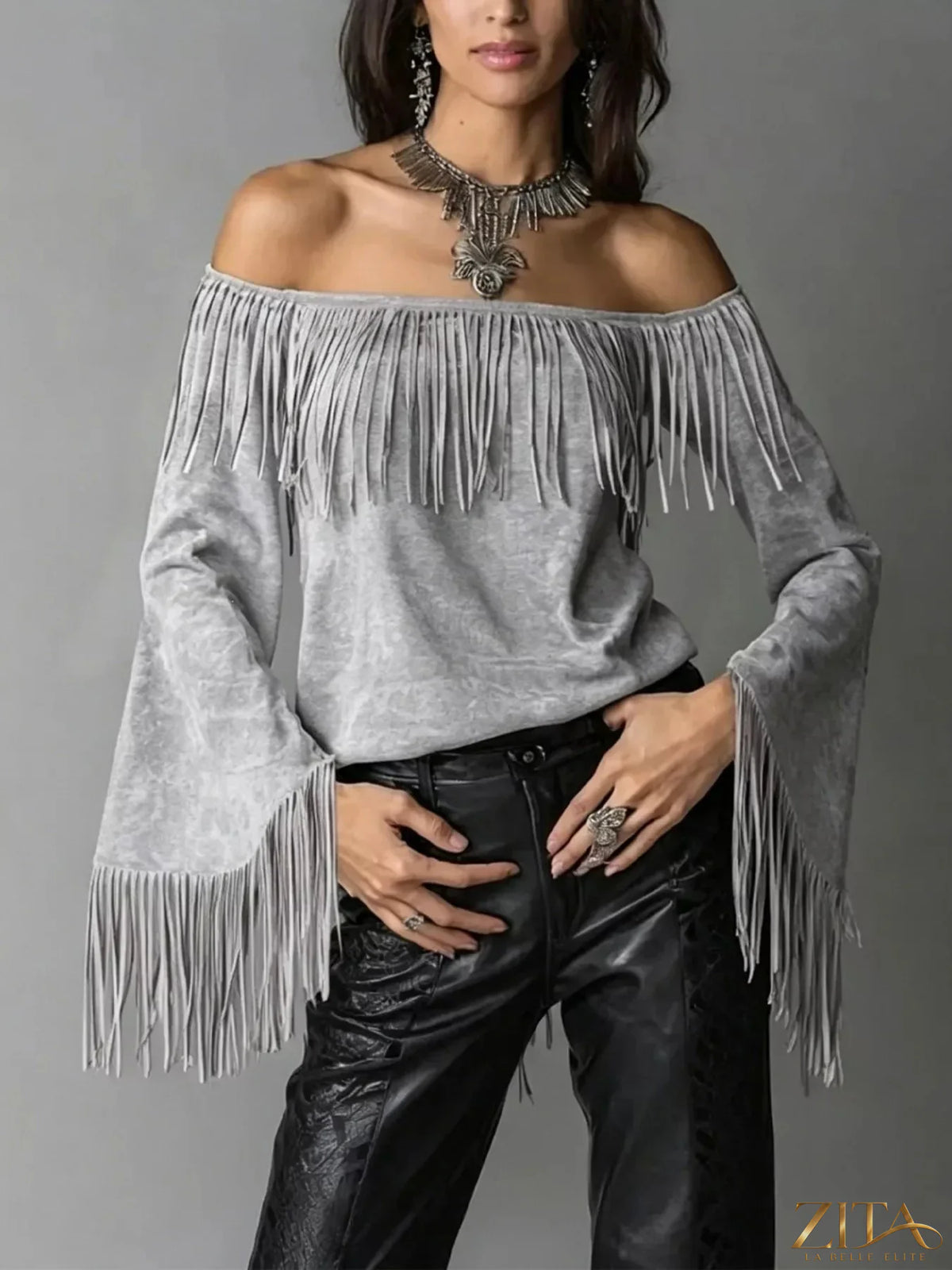 Boho chic off-shoulder fringed suede top by Zita La Belle Elite, showcasing bohemian style with fringe details and off-shoulder design.