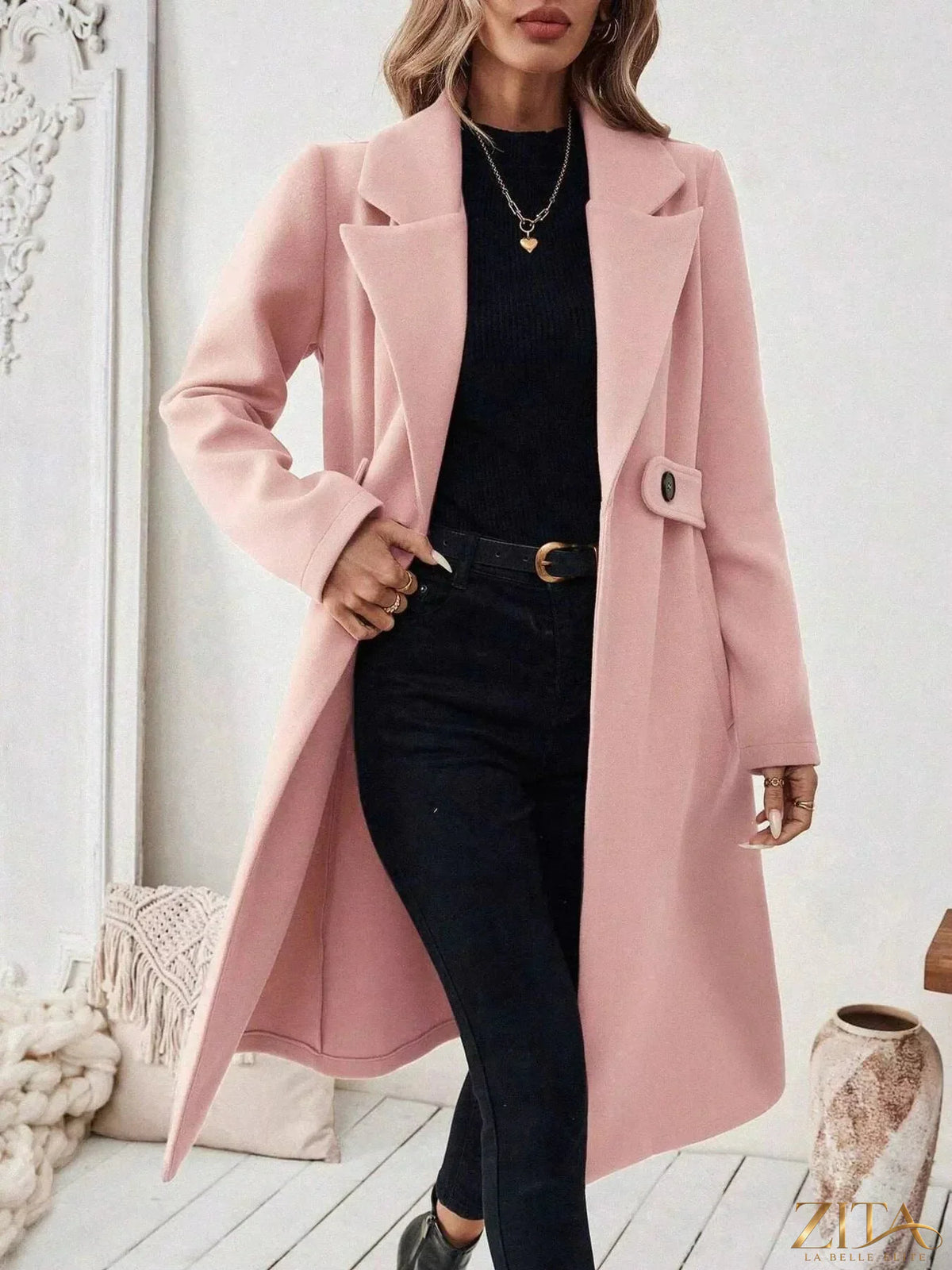Zita La Belle Elite single-button longline coat hanging on a rack, showing its tailored fit and sleek design in neutral fabric.