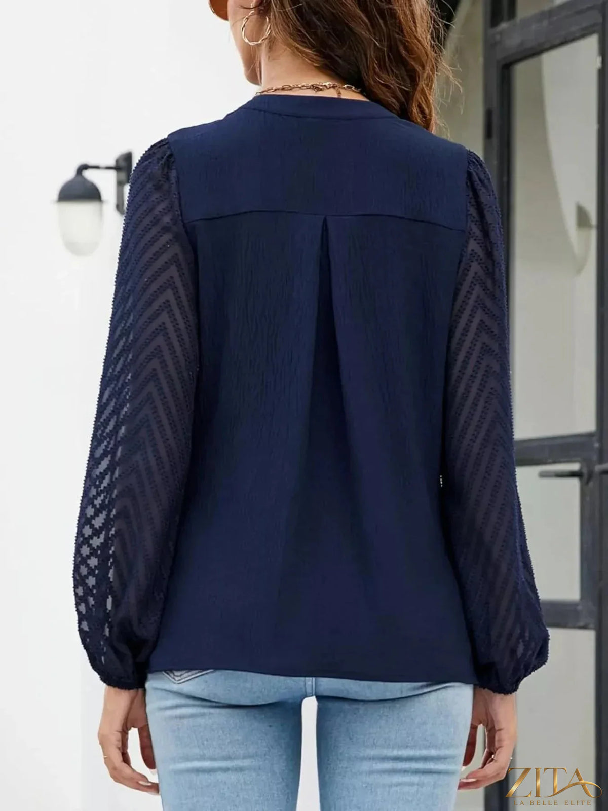 Zita La Belle Elite notched balloon sleeve blouse featuring ruffled cuffs and a relaxed fit, displayed on a white background.
