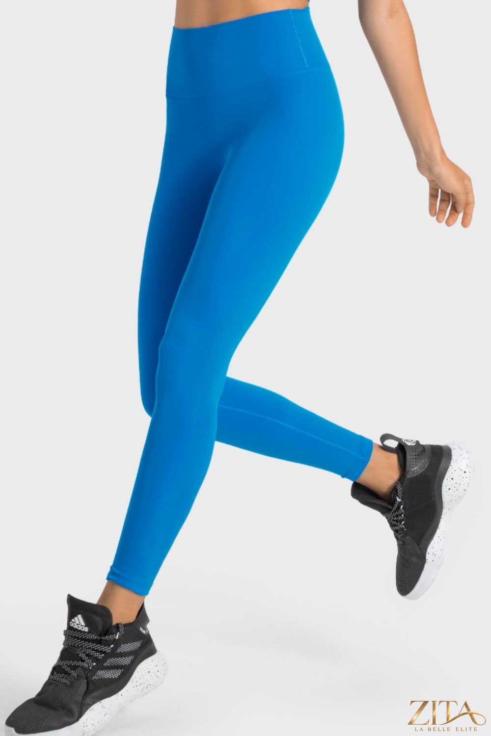 Millennia high-rise yoga leggings by Trendsi with wide waistband, shown in black, stretchy fabric for comfort and support during exercise.