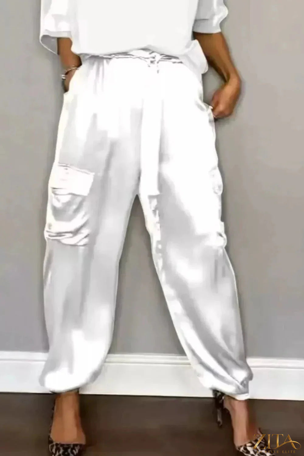 Satin round neck top and matching pants set from Trendsi, featuring a smooth, shiny fabric and relaxed fit for stylish comfort.
