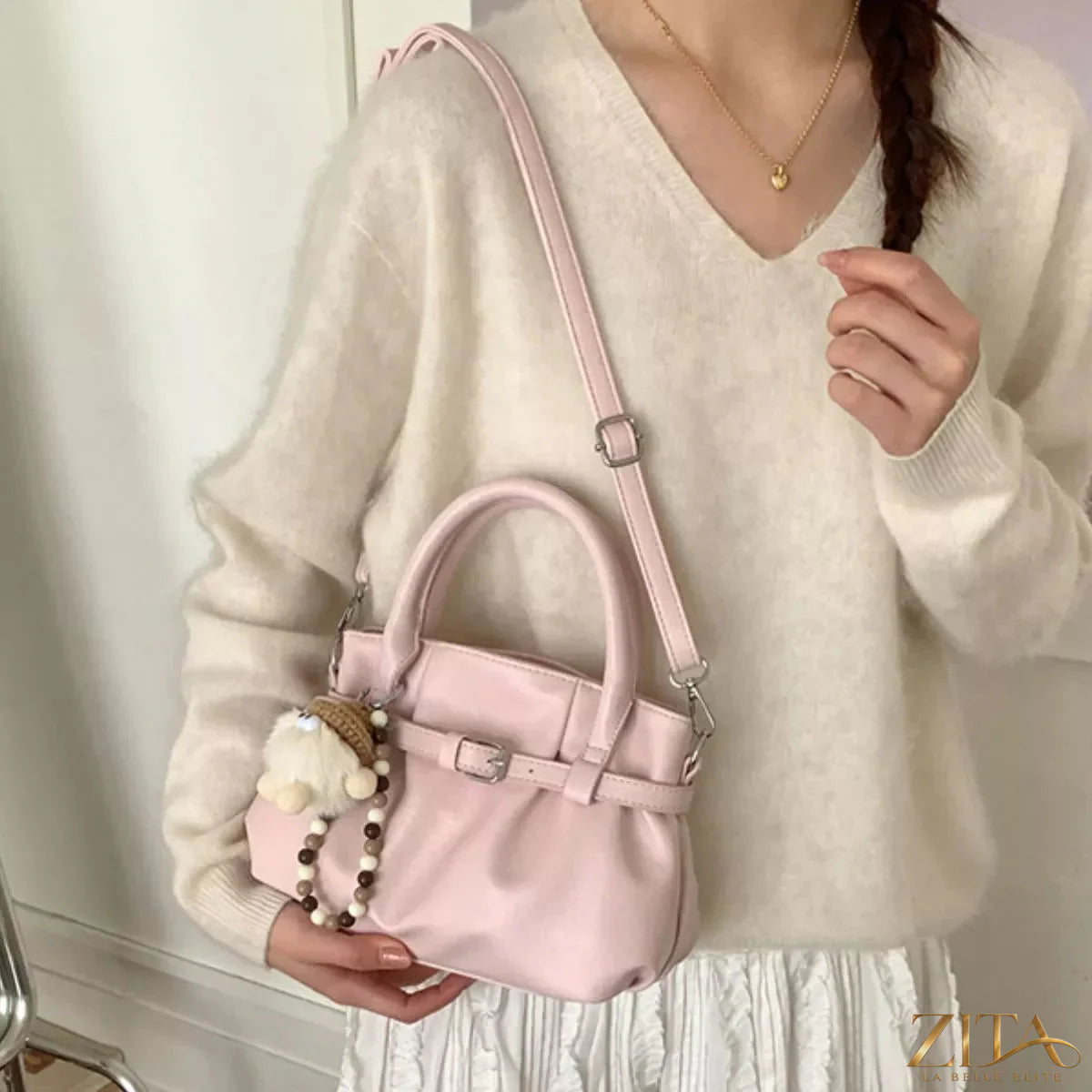 Trendsi PU leather handbag with gold-tone hardware, featuring a structured design and top handle, on a neutral background.