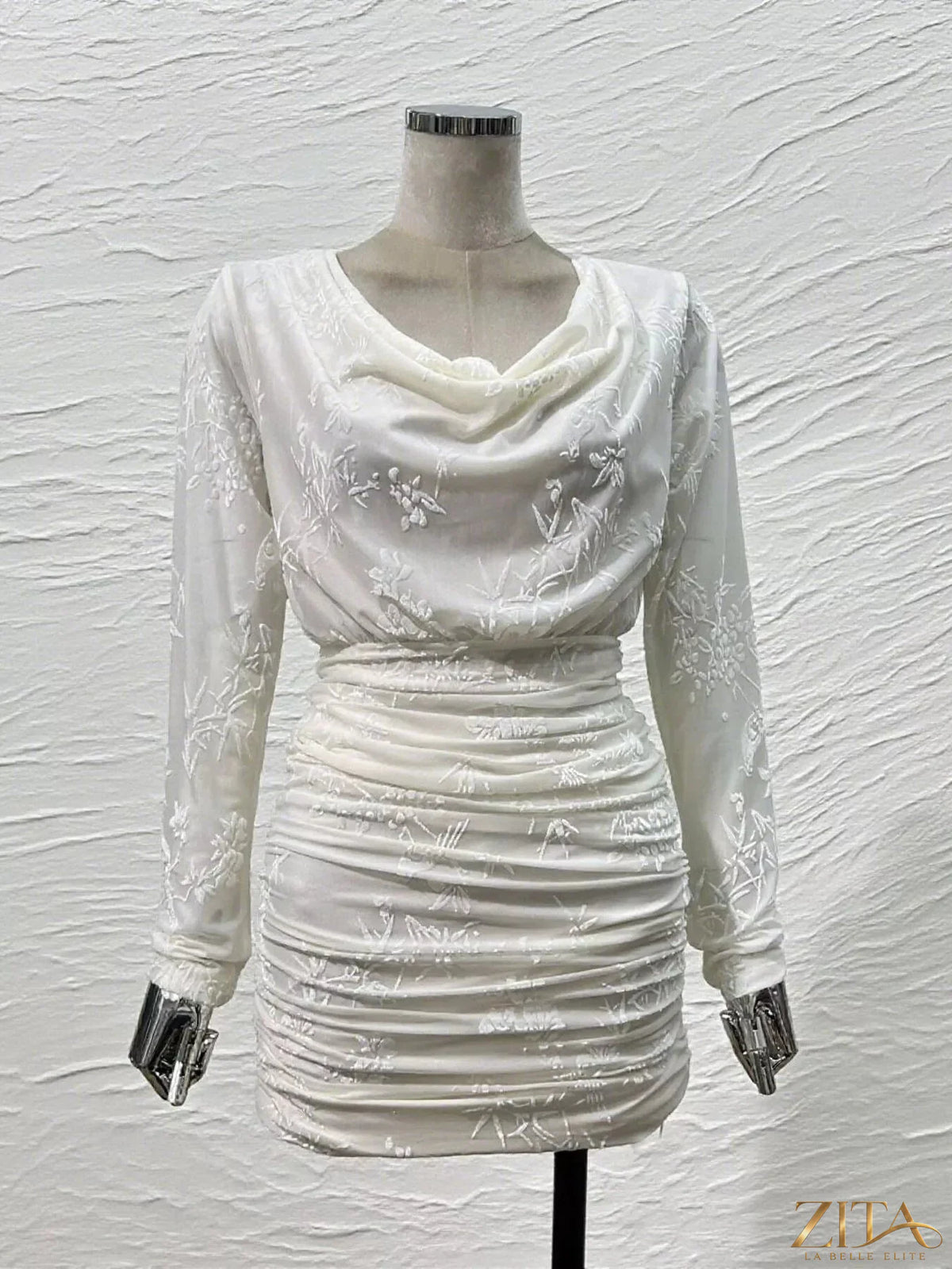Ruched long sleeve mini dress by Trendsi featuring a fitted silhouette and stylish design, shown in a close-up view.