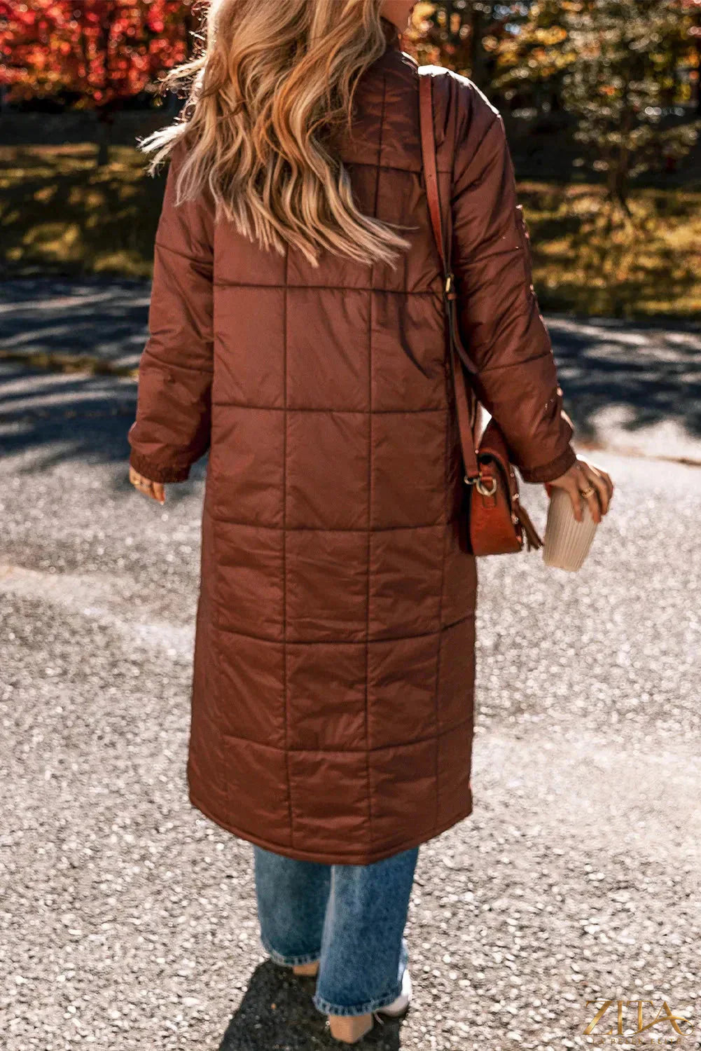 Longline winter coat by Zita La Belle Elite with bubble texture and pocketed design, featuring long sleeves and a cozy winter style.