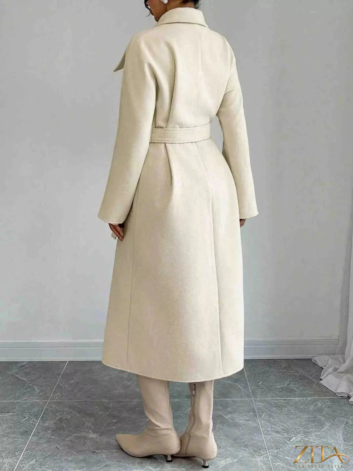 Zita La Belle Elite double-breasted longline coat in neutral fabric, shown on a model with tailored fit and classic lapel design.