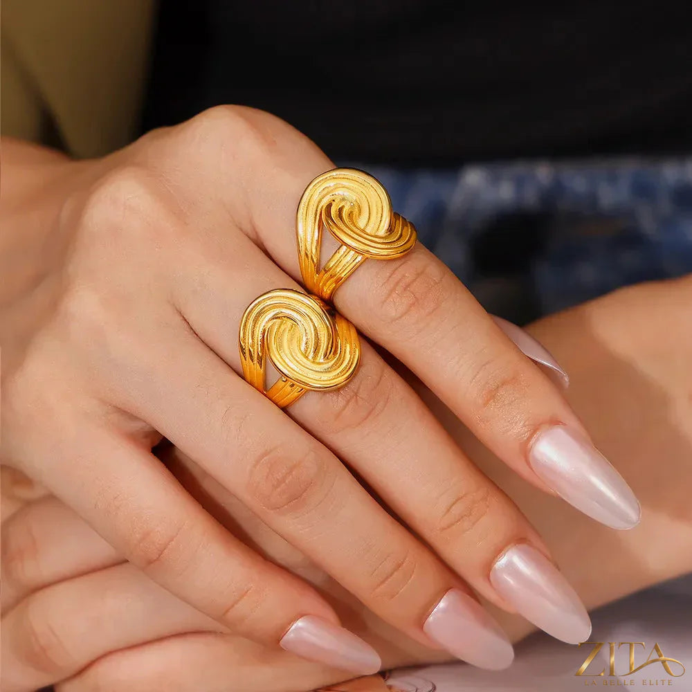 18K gold-plated twisted ring by Zita La Belle Elite, featuring a stylish, intertwined design on a plain background.