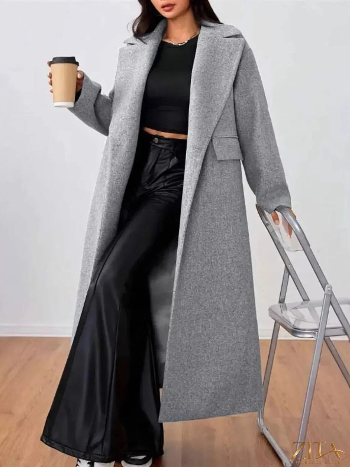Zita La Belle Elite wool-blend longline overcoat hanging on a wooden hanger, showcasing its classic design and tailored fit.