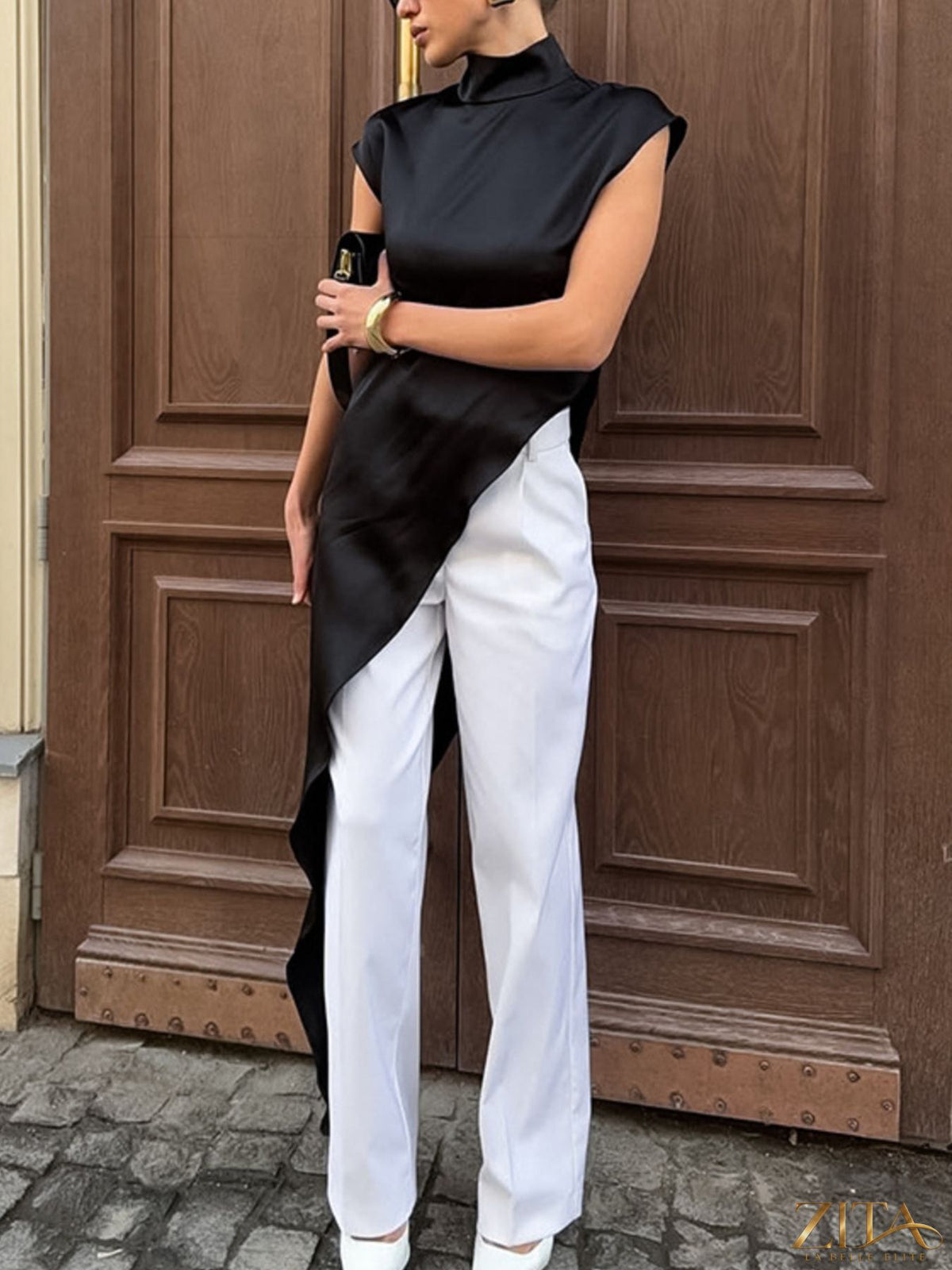 Zita La Belle Elite asymmetrical hem turtleneck blouse featuring a stylish, modern design with a fitted silhouette and unique hem detail.