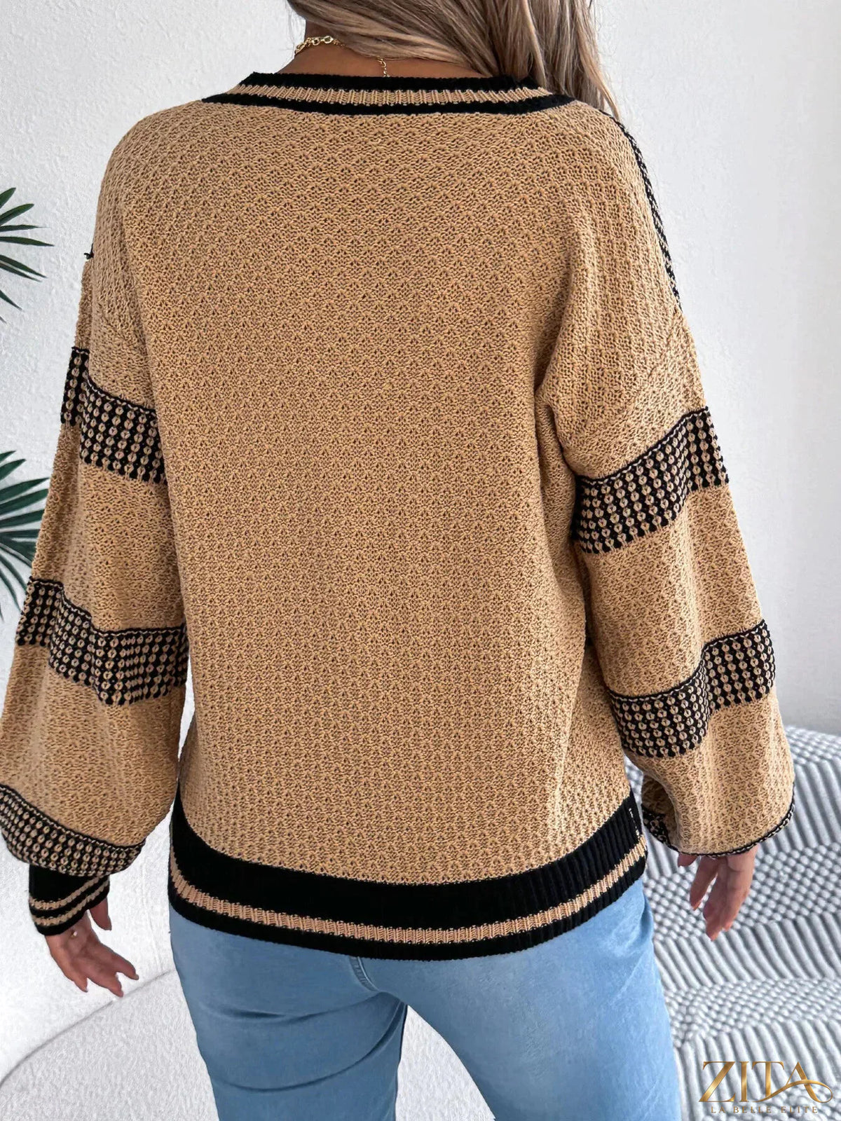 Contrast striped V-neck sweater by Trendsi featuring a stylish pattern and comfortable fit, shown in the image.
