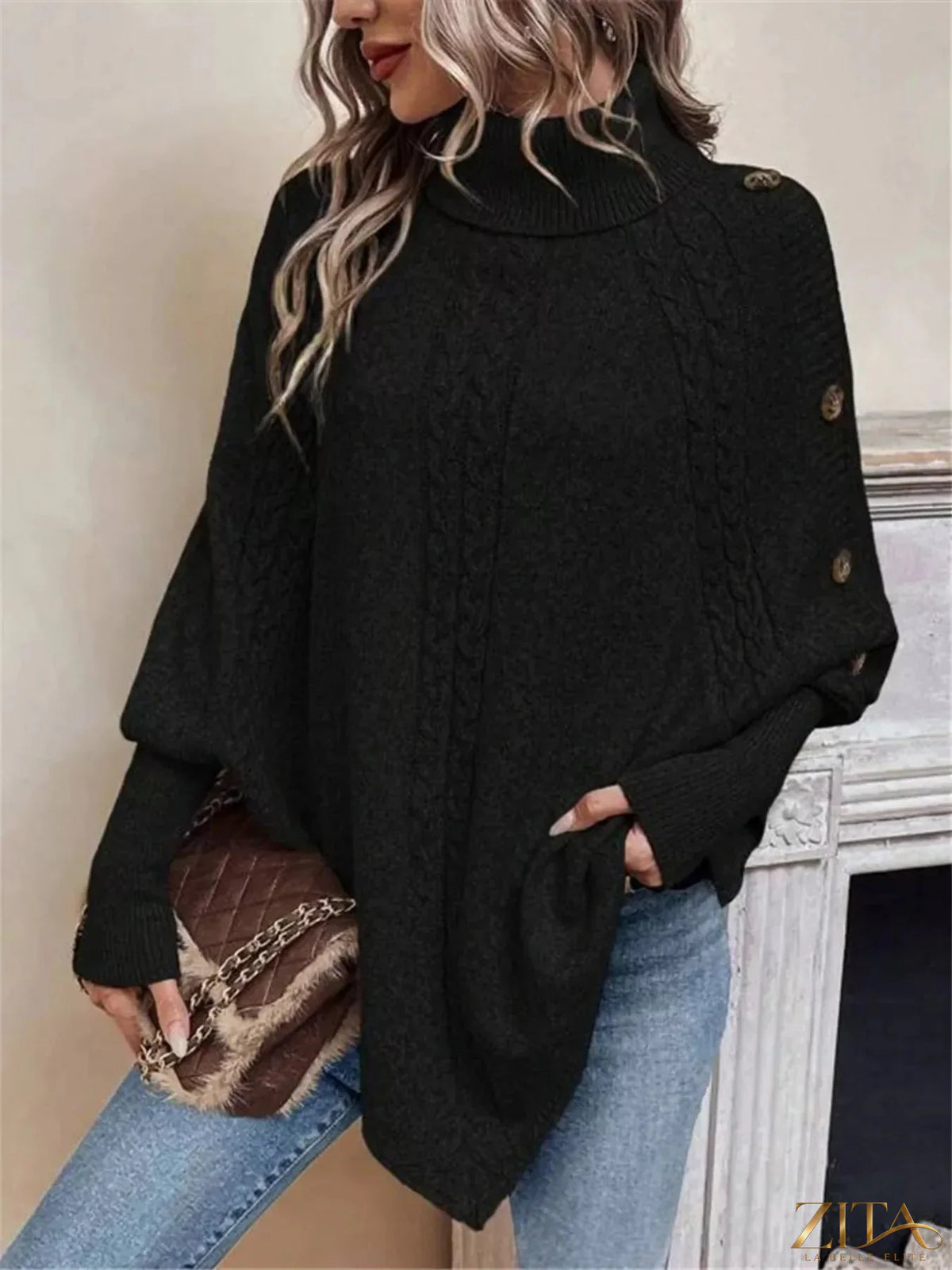 Cable knit turtleneck cape sweater from Trendsi, featuring a cozy, textured design with a high neckline and flowing silhouette.