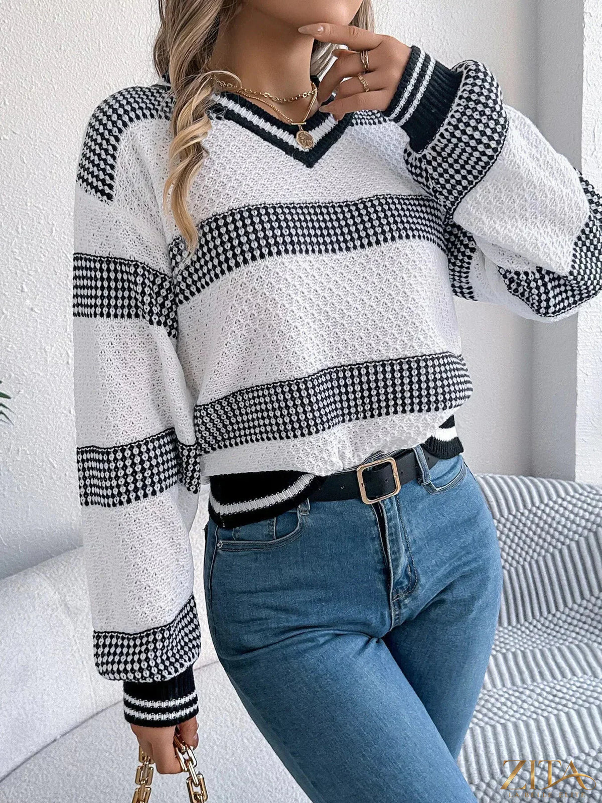 Contrast striped V-neck sweater from Trendsi featuring bold horizontal stripes and a classic V-neck design.