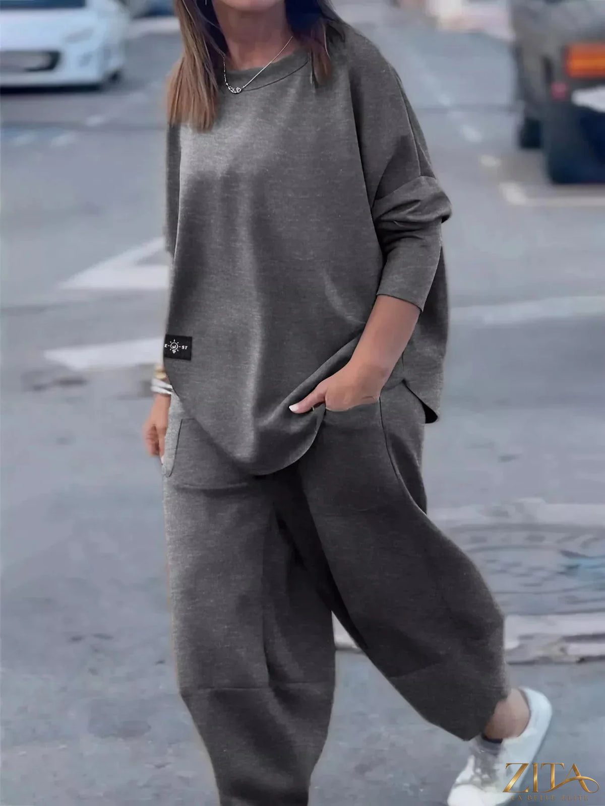 Plus size casual loose fit top and pants two-piece set by Trendsi, comfortable and stylish for everyday wear.