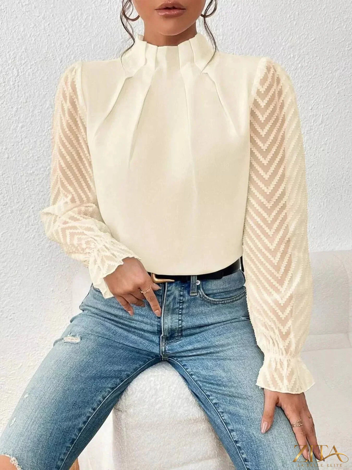 Zita La Belle Elite mock neck sheer lace sleeve blouse displayed on a hanger with intricate lace details and lightweight fabric