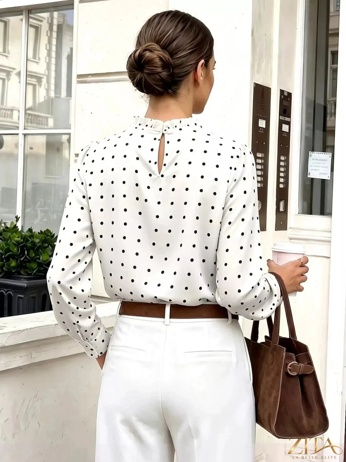 Zita La Belle Elite elegant polka dot print mock neck long sleeve blouse with ruffled details on a model.