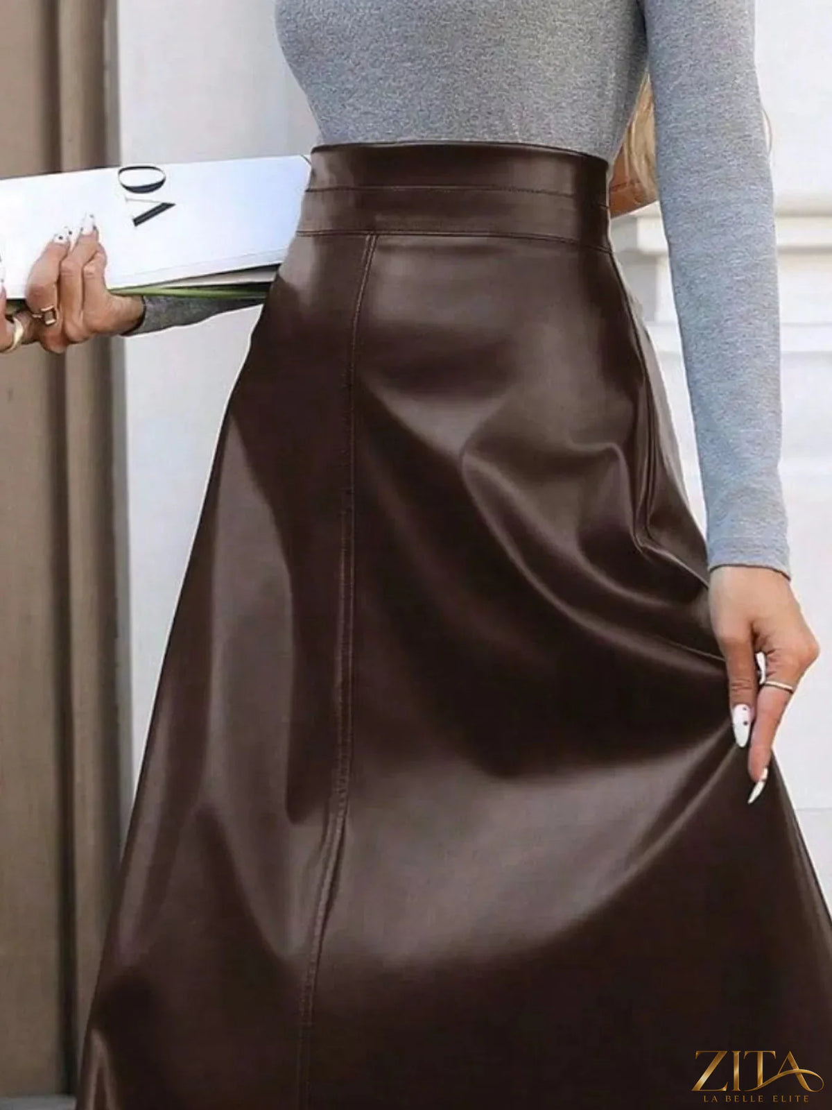 Leather A-line midi skirt by Trendsi featuring a sleek design, high waist, and smooth leather texture.