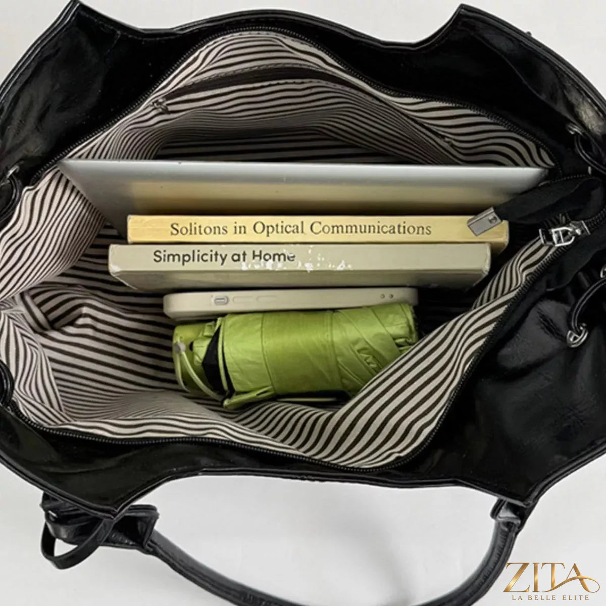 Drawstring leather handbag with adjustable straps and sleek design, featuring a trendy and stylish look from Trendsi.