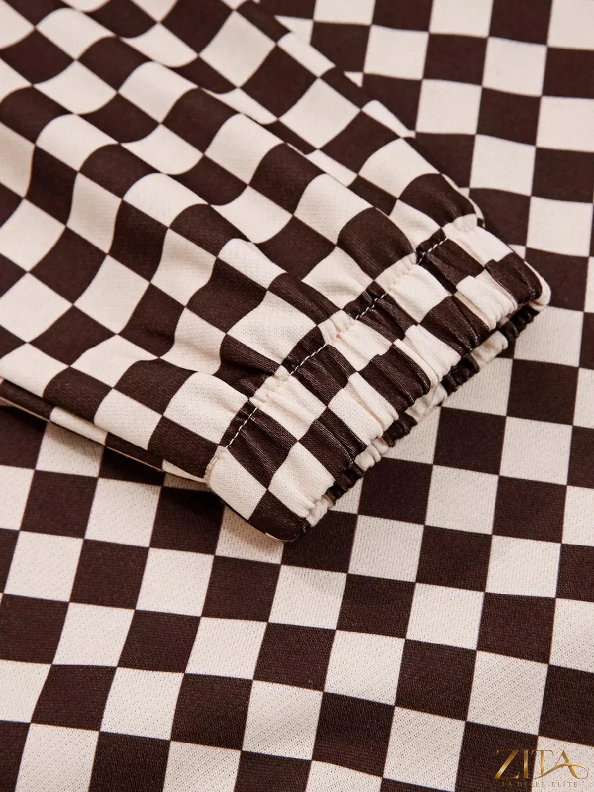 Checkered Zita La Belle Elite hoodie and pants set with drawstrings, featuring a stylish black and white checkered pattern.
