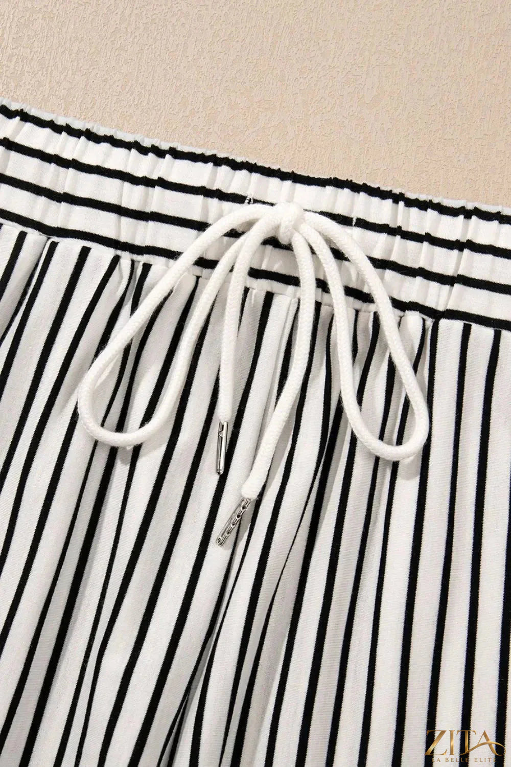 Stripe V-neck tee and casual shorts set by Trendsi, two-piece outfit with a striped V-neck top and matching shorts, casual style.