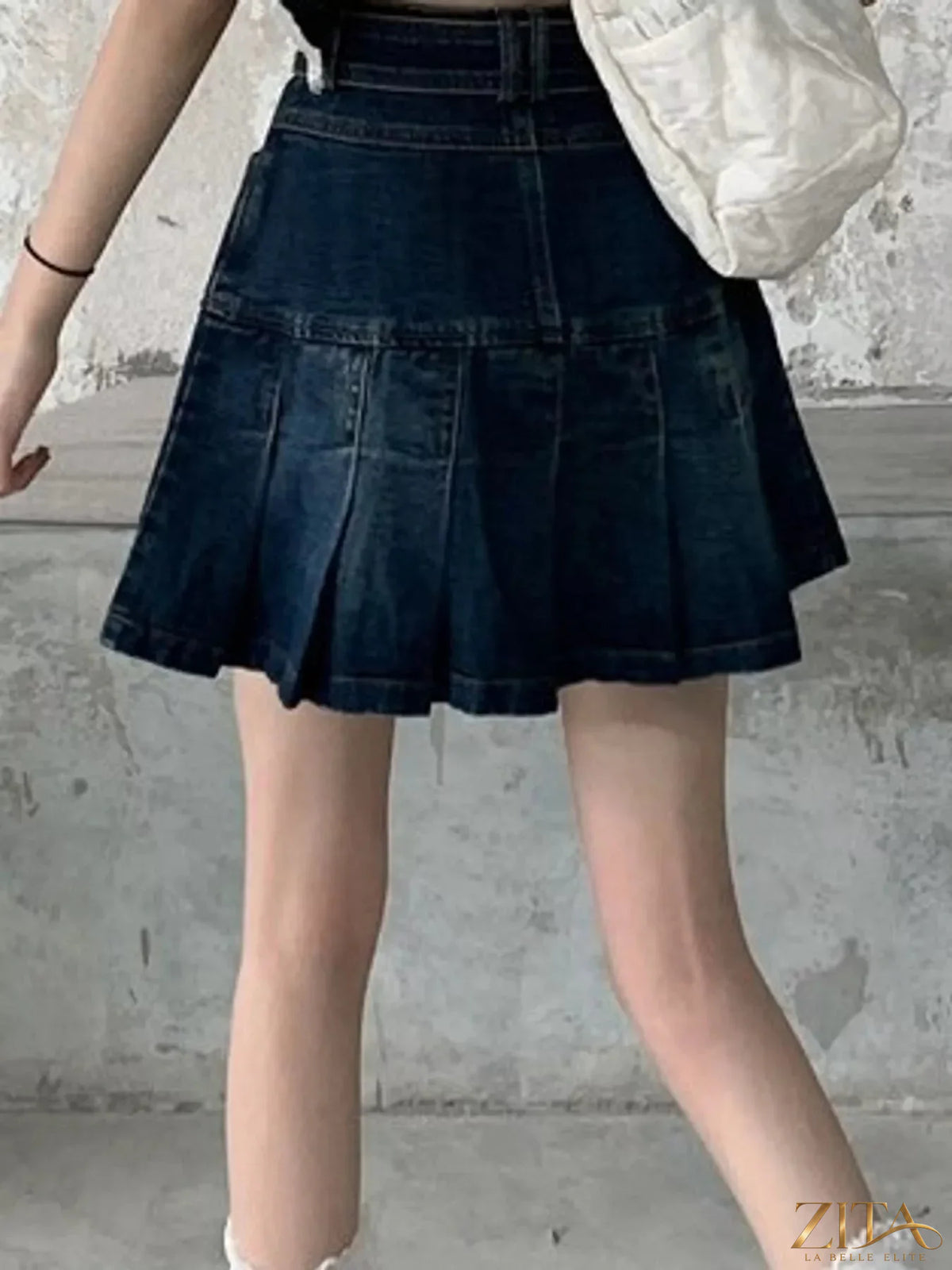 High-waisted pleated denim skirt by Trendsi, featuring a classic denim fabric with stylish pleats and a fitted waistband.