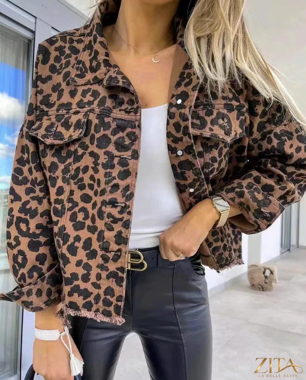 Leopard collar denim jacket with raw hem, featuring classic blue denim and trendy animal print details.
