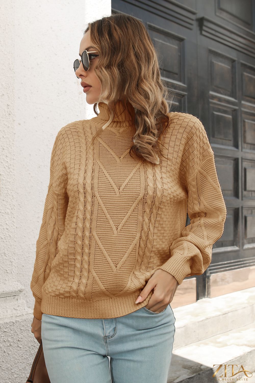 Zita La Belle Elite cable-knit turtleneck sweater in cozy wool, showcasing its textured knit pattern and high neckline.