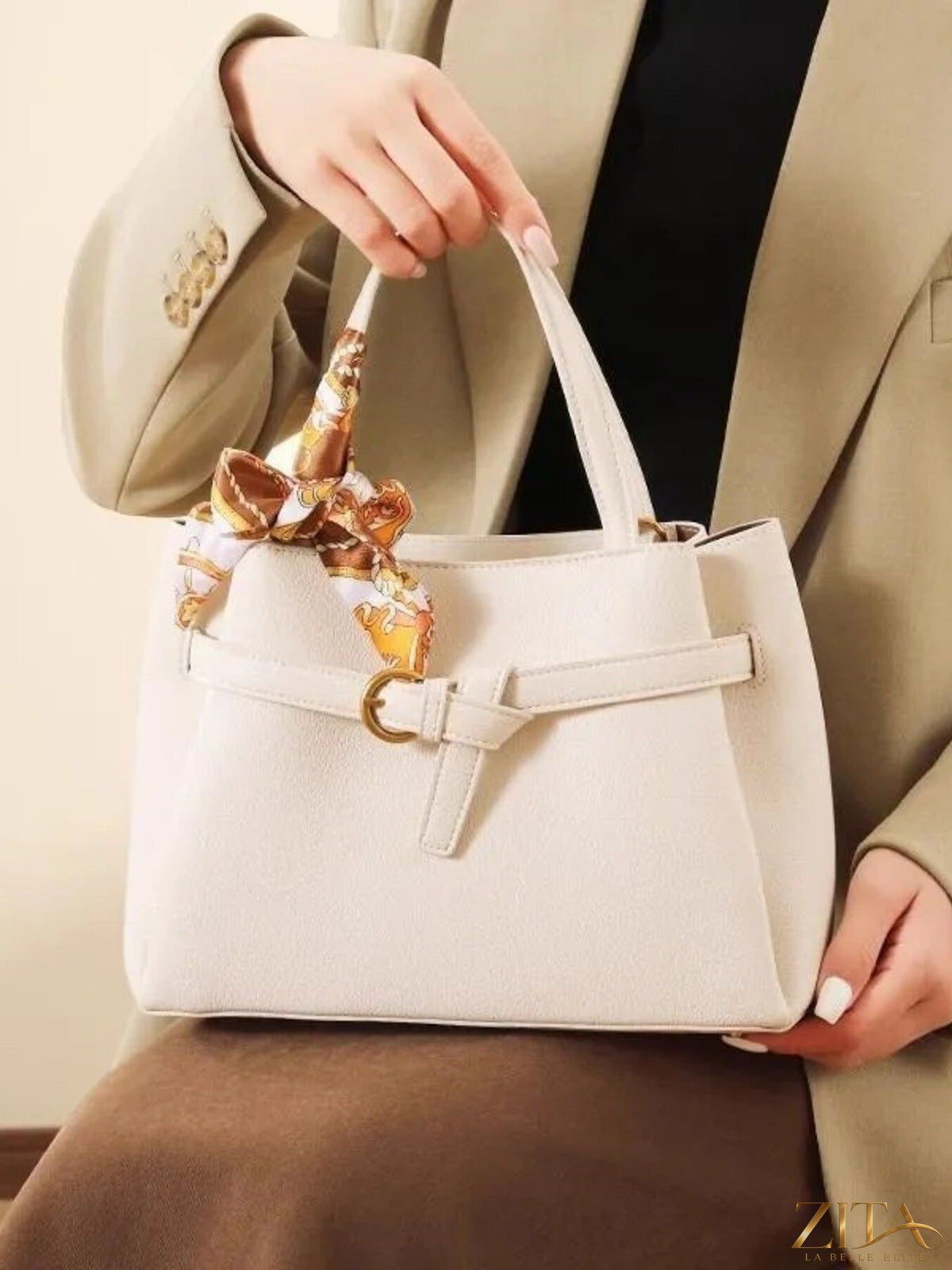 Zita La Belle Elite leather top handle handbag with structured design and rounded handles, in a rich brown color.