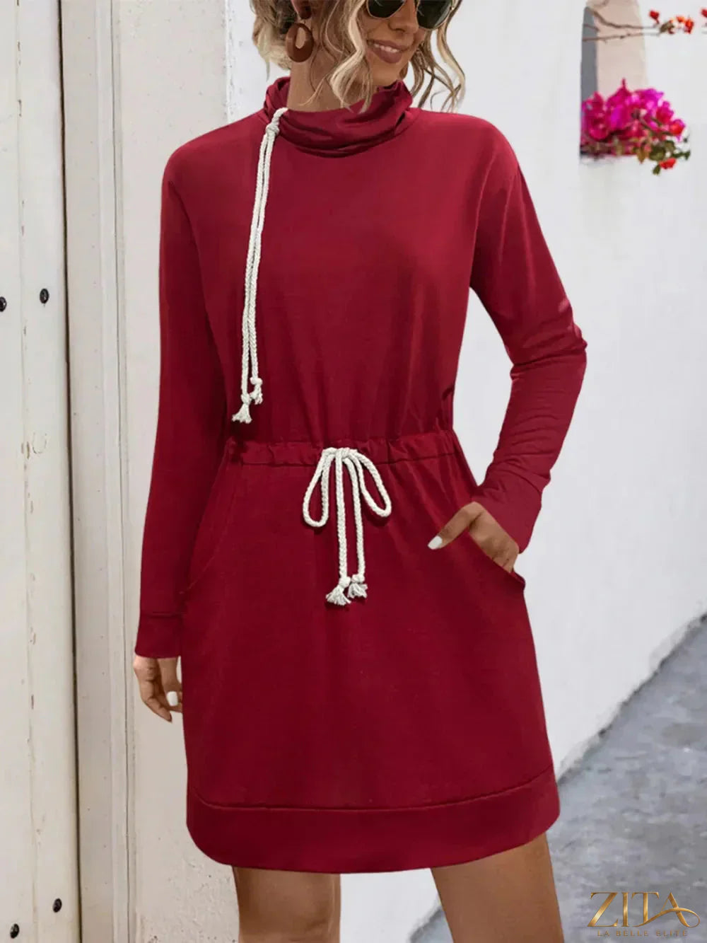 Drawstring turtleneck long sleeve mini dress by Trendsi, featuring a fitted silhouette and stylish design in the image.