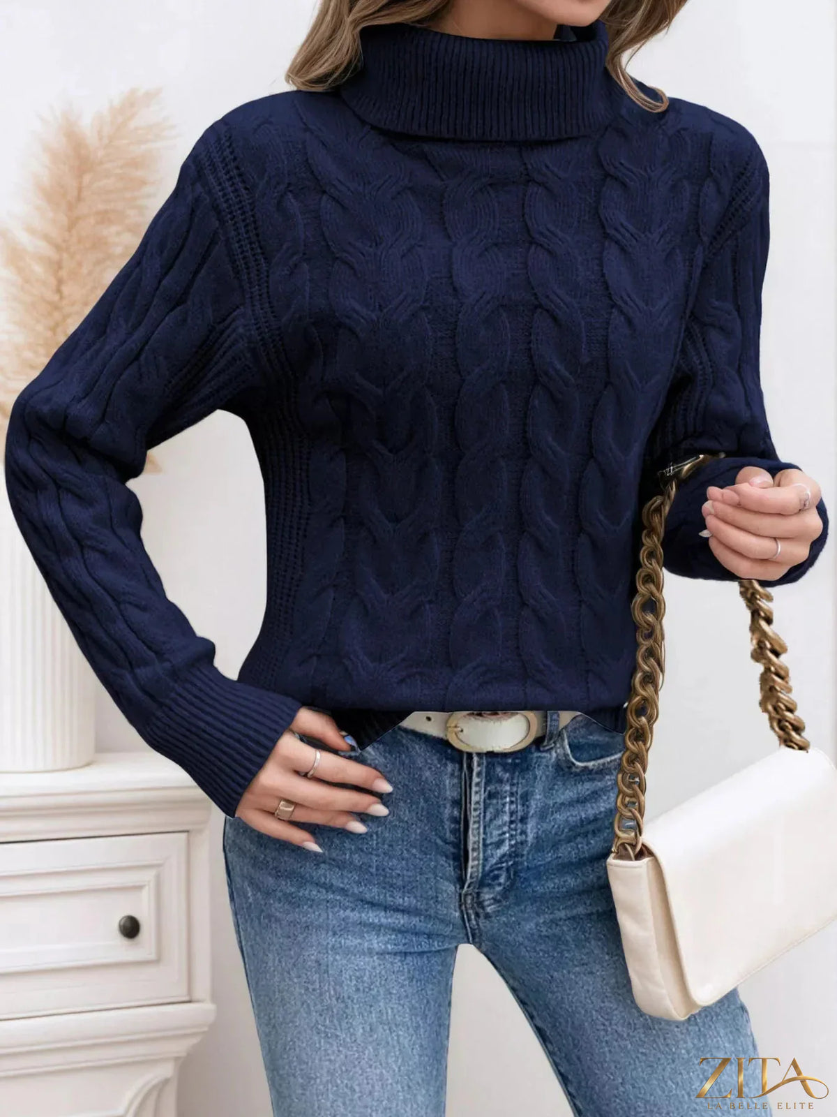 Cable-knit turtleneck sweater by Zita La Belle Elite, featuring a cozy, textured knit pattern and a high turtleneck collar.