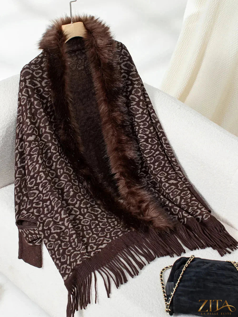 Leopard print fringe open front long sleeve poncho by Trendsi, featuring a stylish design with tassel details.