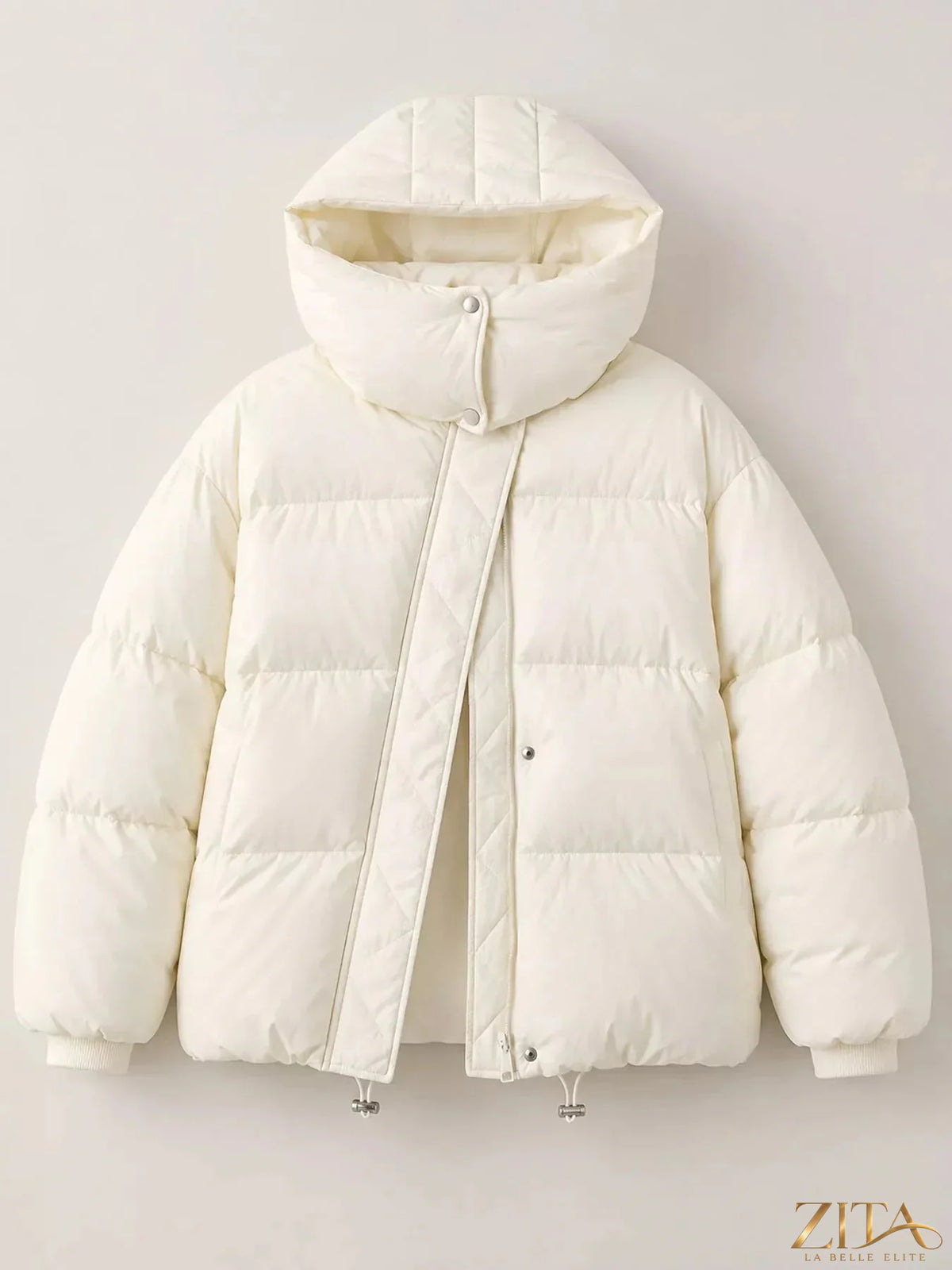Zita La Belle Elite quilted hooded puffer jacket with insulated design and front zipper, shown on a model in a city outdoor setting.