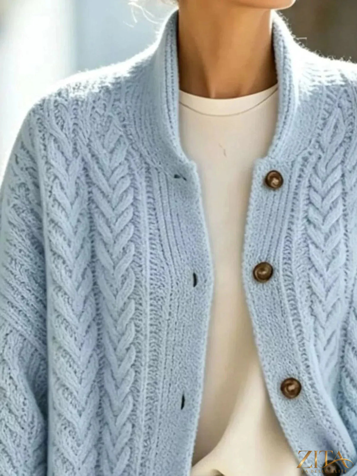 Plus size cable-knit button-down cardigan by Zita La Belle Elite, featuring a cozy full-size knit with buttons down the front.