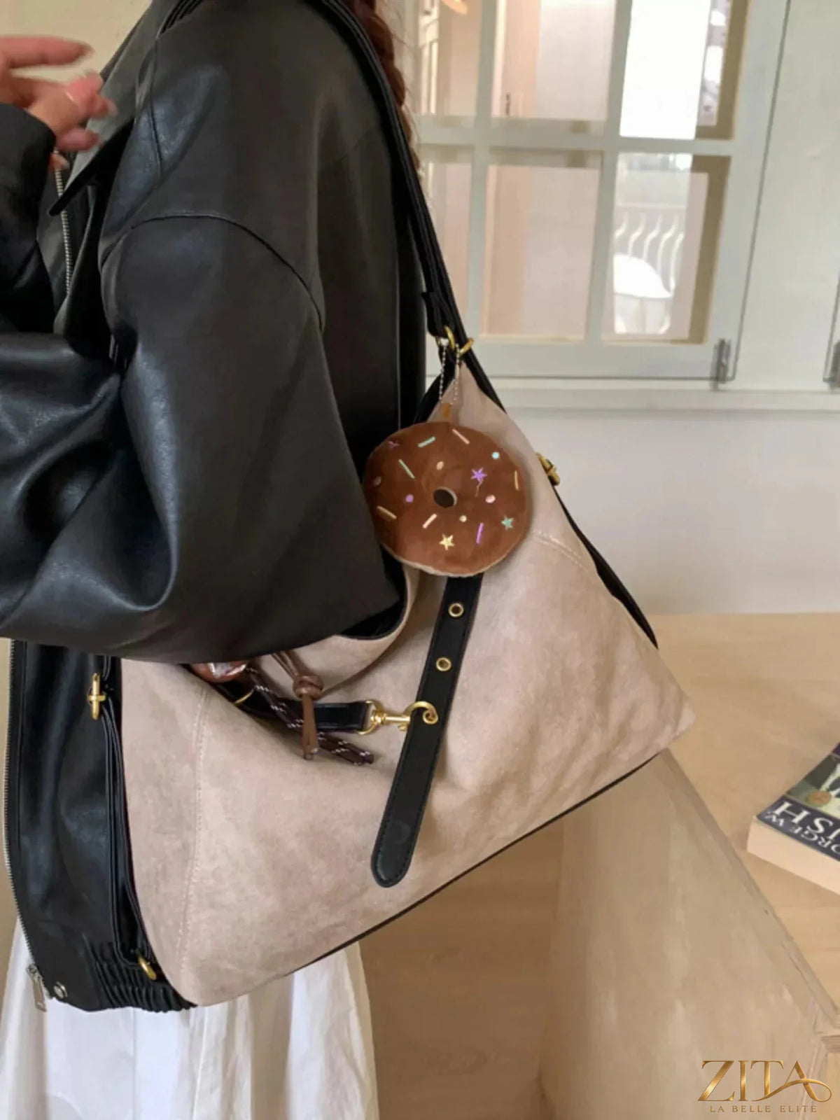 Zita La Belle Elite adjustable strap handbag with decorative charm, featuring a sleek design and elegant hardware.