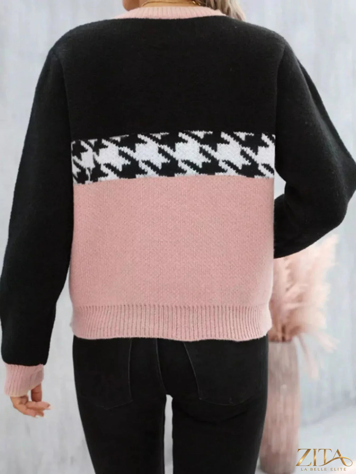 Color block houndstooth sweater in black, white, and red featuring a cozy, stylish knit design from Trendsi.
