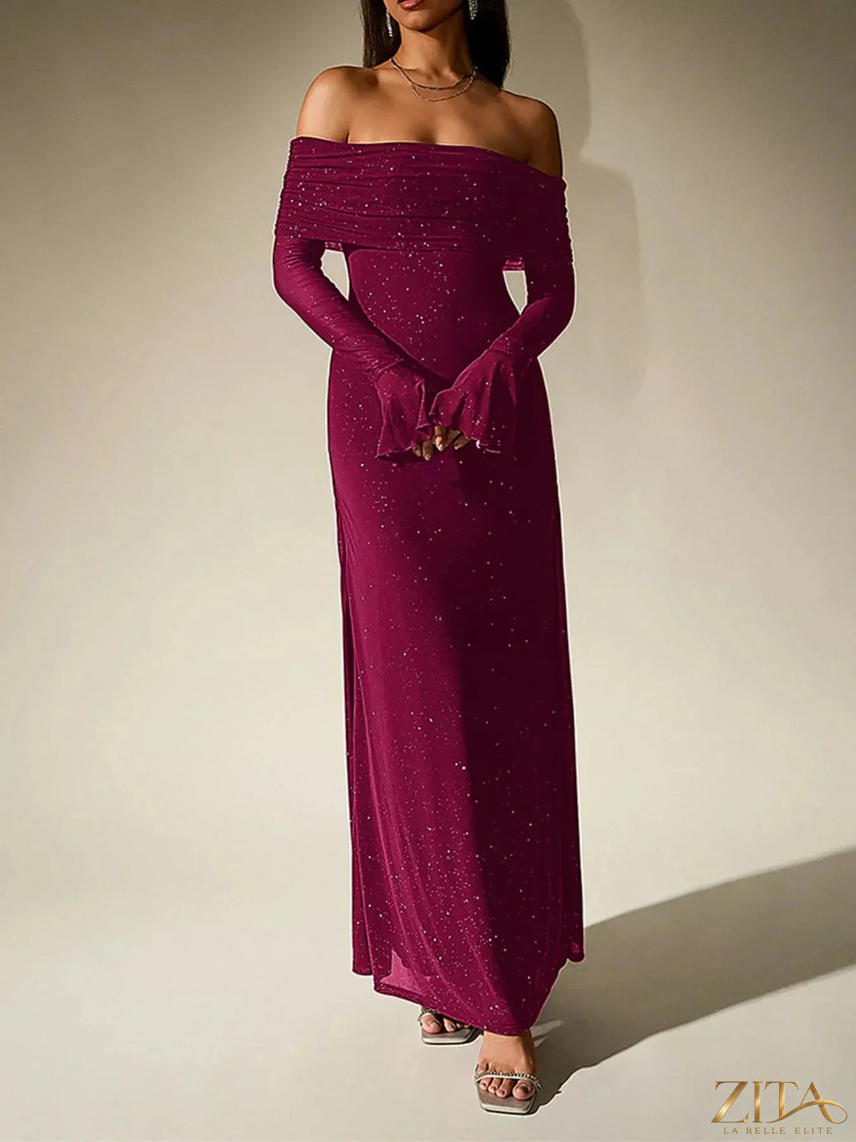 Sparkling off-shoulder maxi dress by Zita La Belle Elite featuring glitter fabric, flowing silhouette, and elegant neckline.