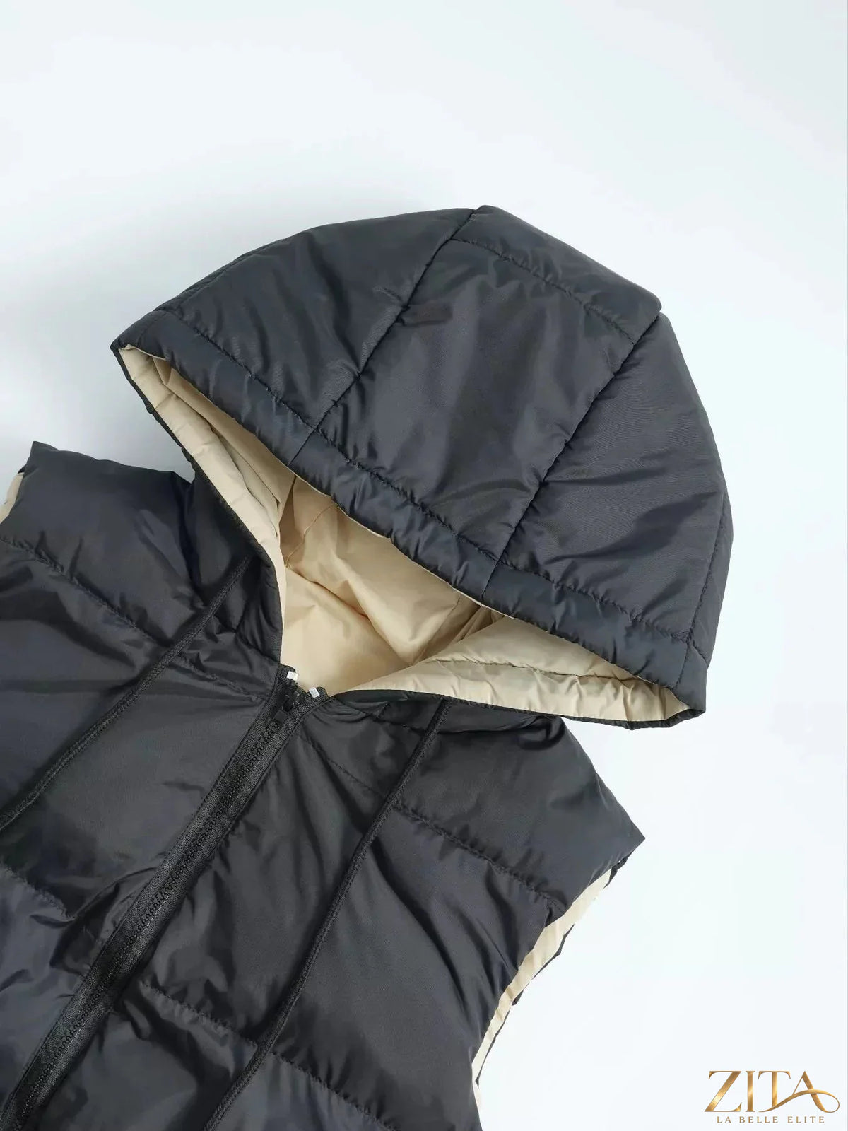 Zita La Belle Elite longline padded hooded vest coat shown in black with a high collar and quilted design for warmth and style.
