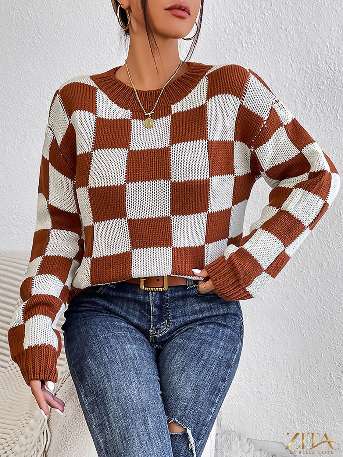 Checkered round neck sweater by Trendsi featuring a stylish black and white checkered pattern and a cozy fit.