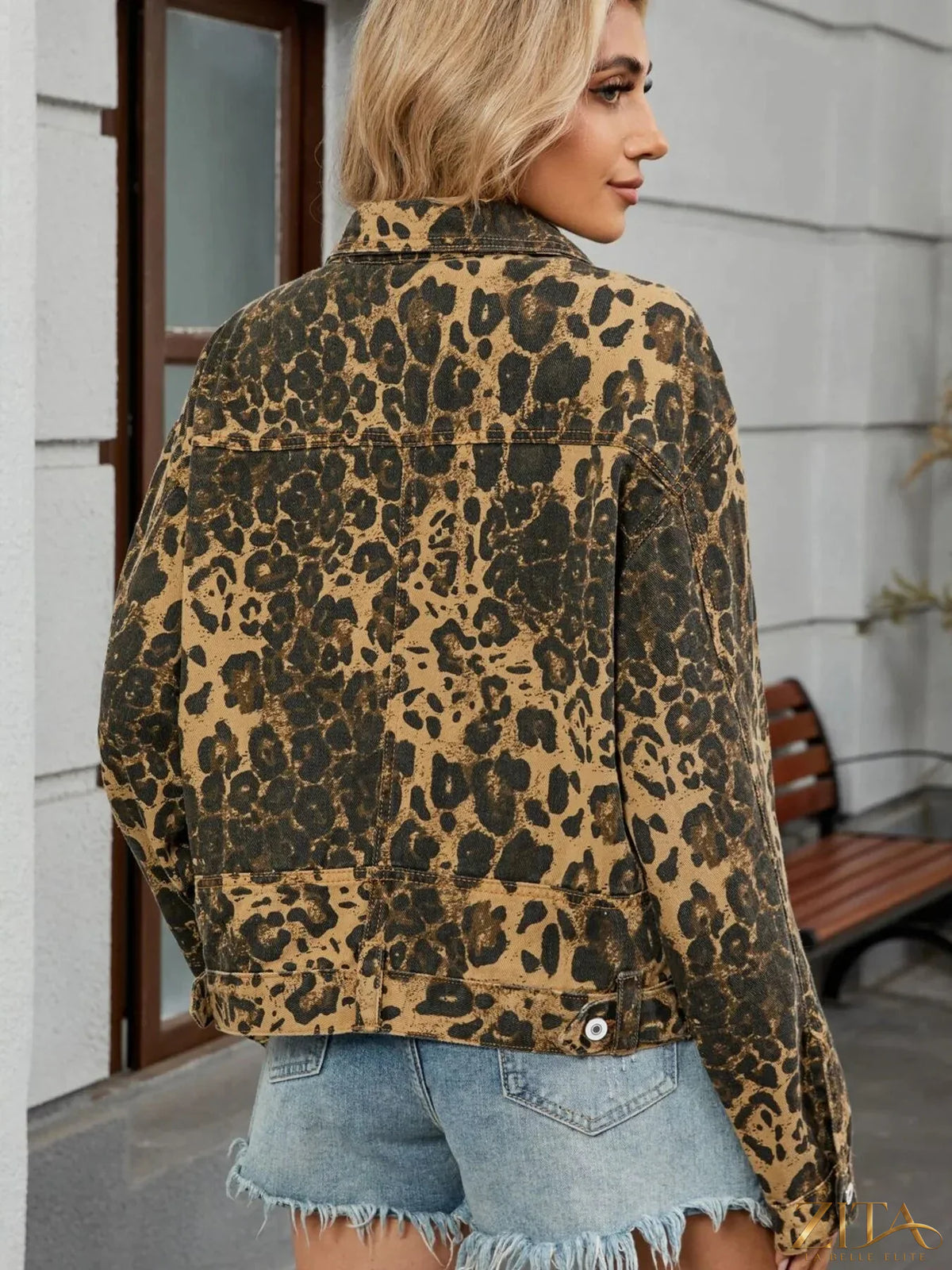 Leopard print button-up denim jacket by Trendsi, featuring classic denim fabric with bold animal print pattern and front button closure.