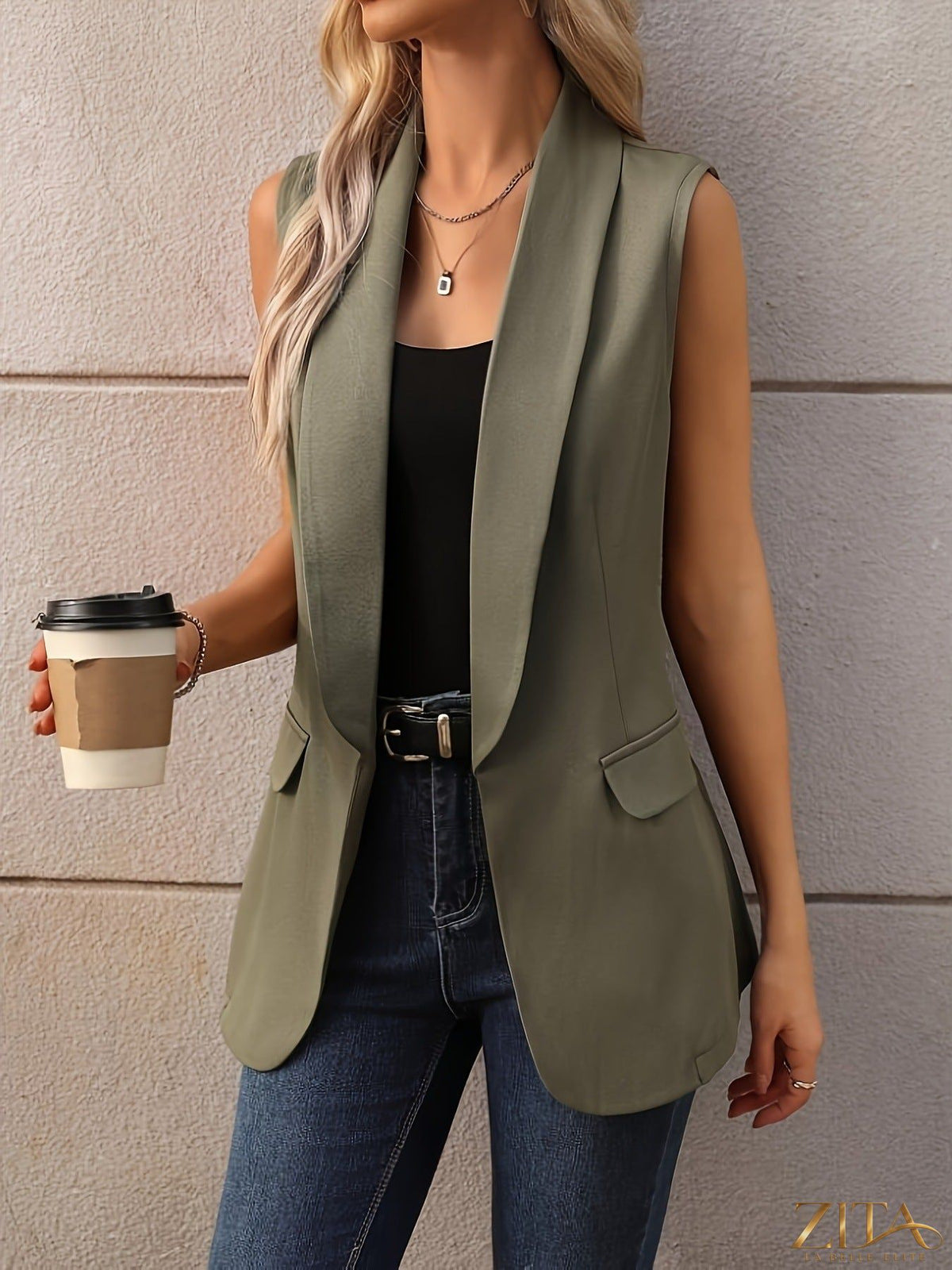 Zita La Belle Elite sleeveless shawl collar vest coat in neutral fabric, styled open with front pockets visible.