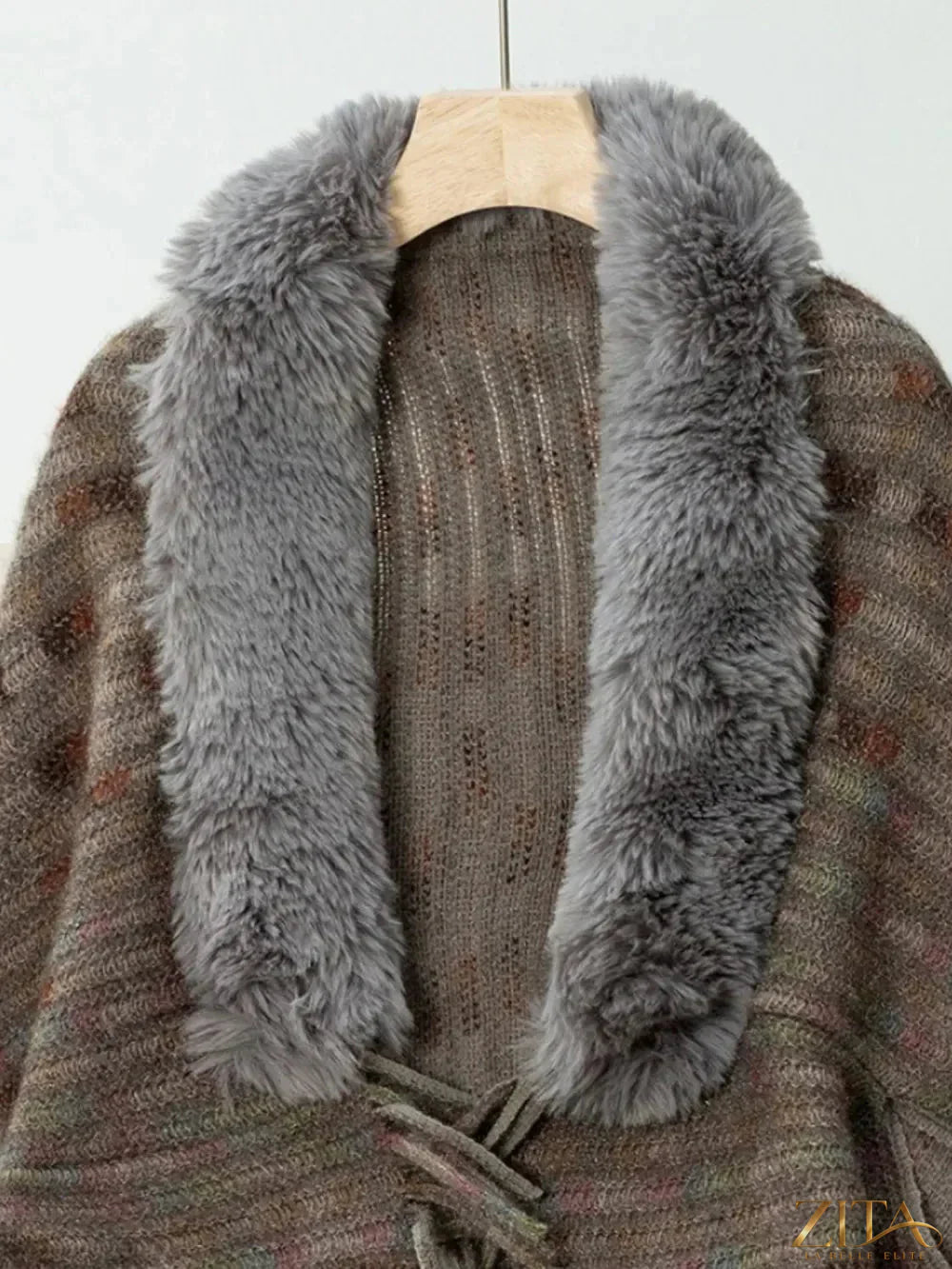 Fuzzy open front fringe poncho in neutral tones, stylish and cozy, with tassel details from Trendsi.