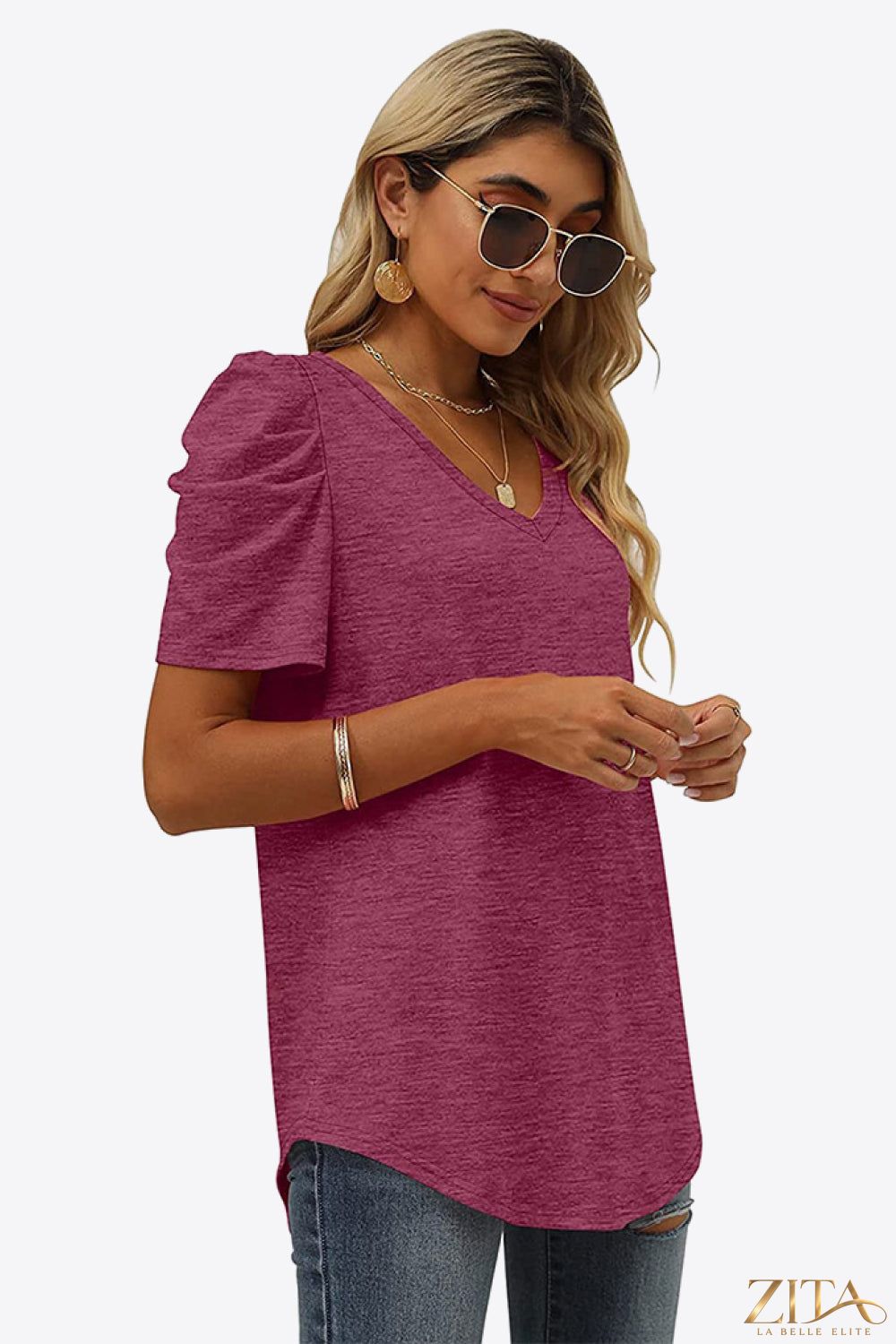 V-neck puff sleeve T-shirt from Trendsi featuring a relaxed fit and stylish puffed sleeves, shown in a natural fabric display.