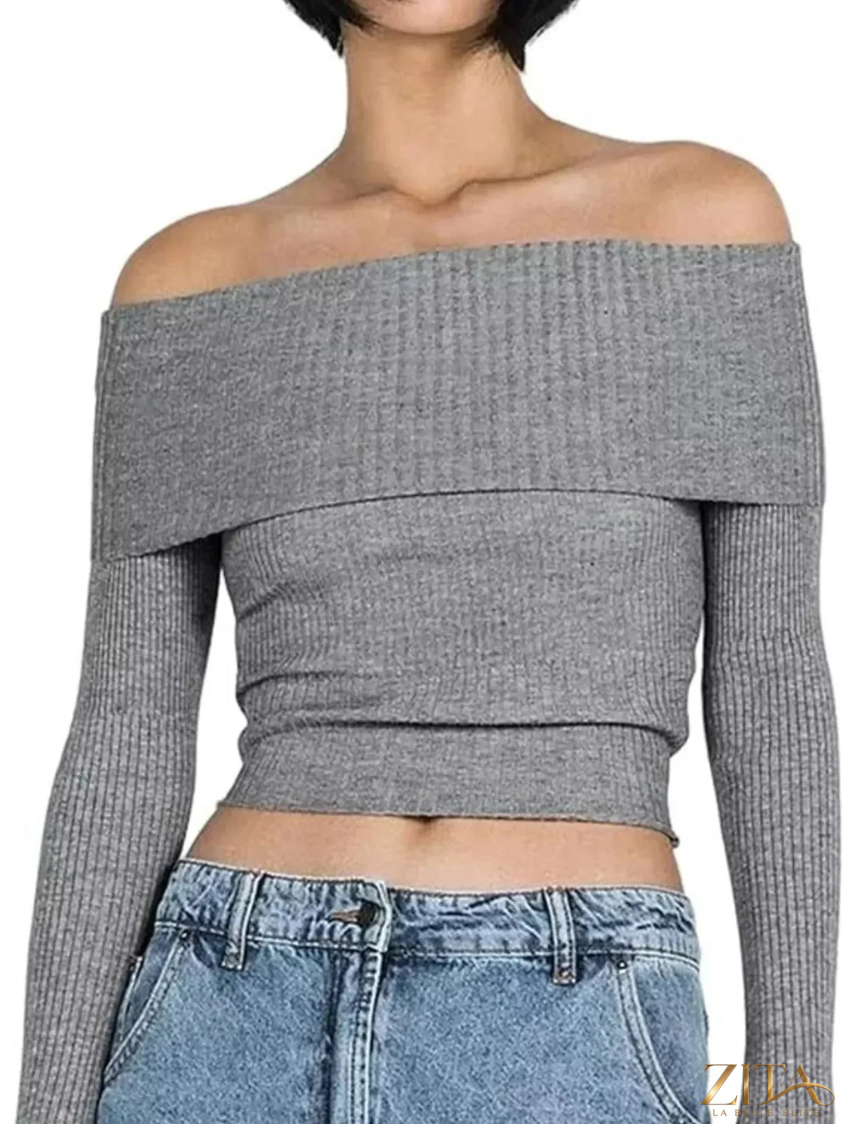 Off-shoulder ribbed knit sweater by Trendsi featuring a fitted design and long sleeves, shown in a cozy, textured fabric.