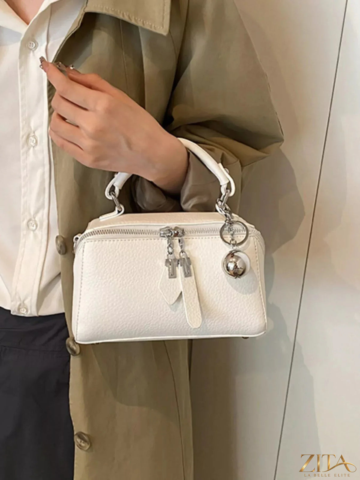 Textured leather handbag with top handles and silver hardware, showcasing a stylish Trendsi designer accessory.