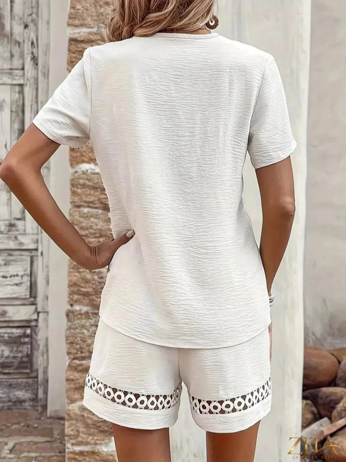 Lace trim V-neck top and matching shorts two-piece set by Trendsi, featuring delicate lace details and comfortable fit.