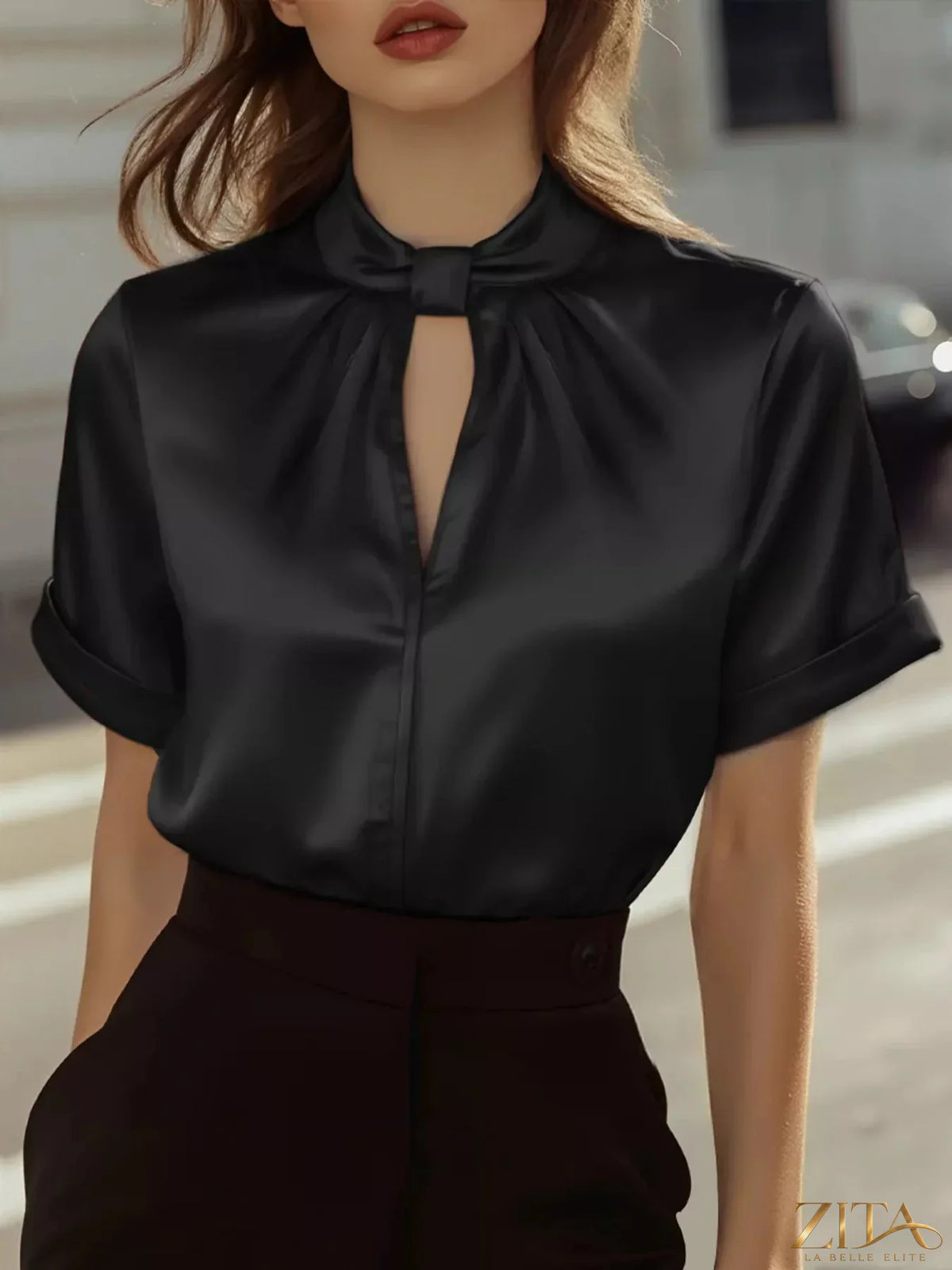 Zita La Belle Elite keyhole neck satin short sleeve blouse with elegant design and smooth fabric, displayed on a hanger.